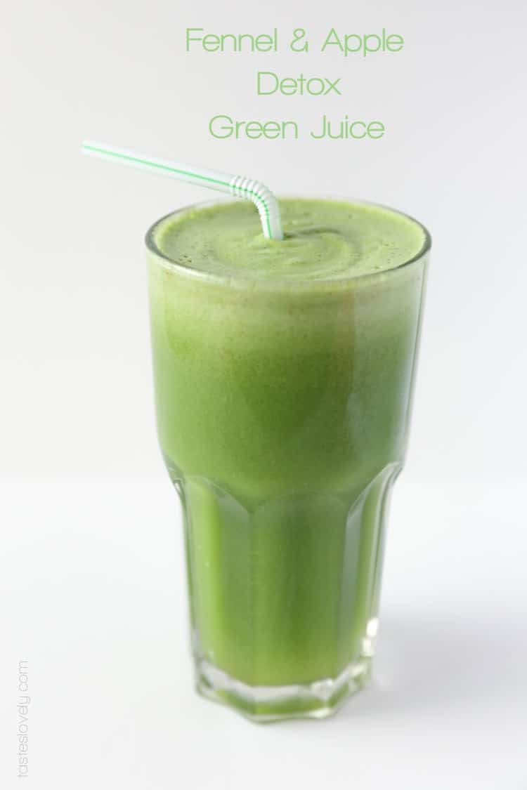 a glass of detox green juice with a straw