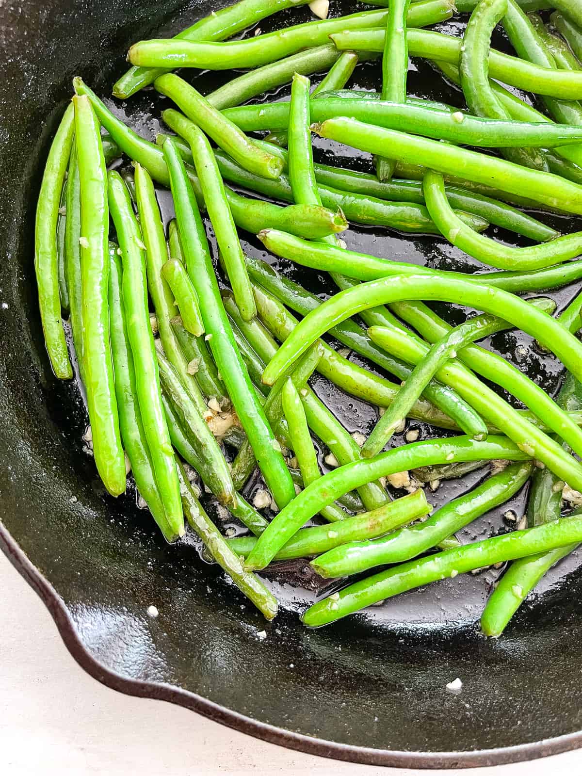 fresh green beans in a cast iron skillet