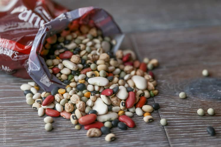 a bag of mixed beans spilling out on a table