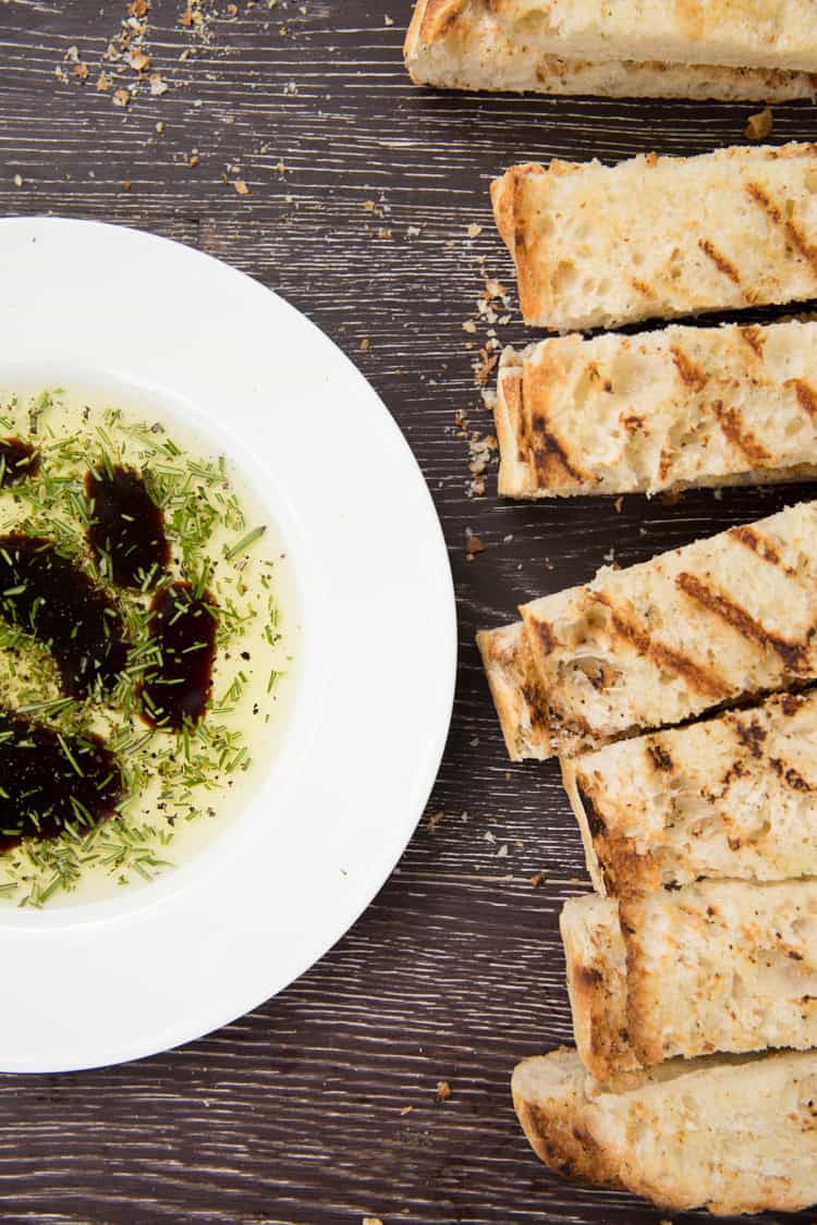 Garlic rubbed grilled bread with rosemary dipping oil. Perfect summer appetizer or side dish!