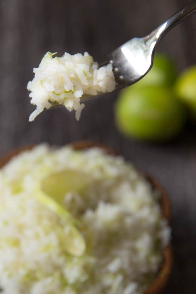 a fork holding a scoop of coconut lime rice. 