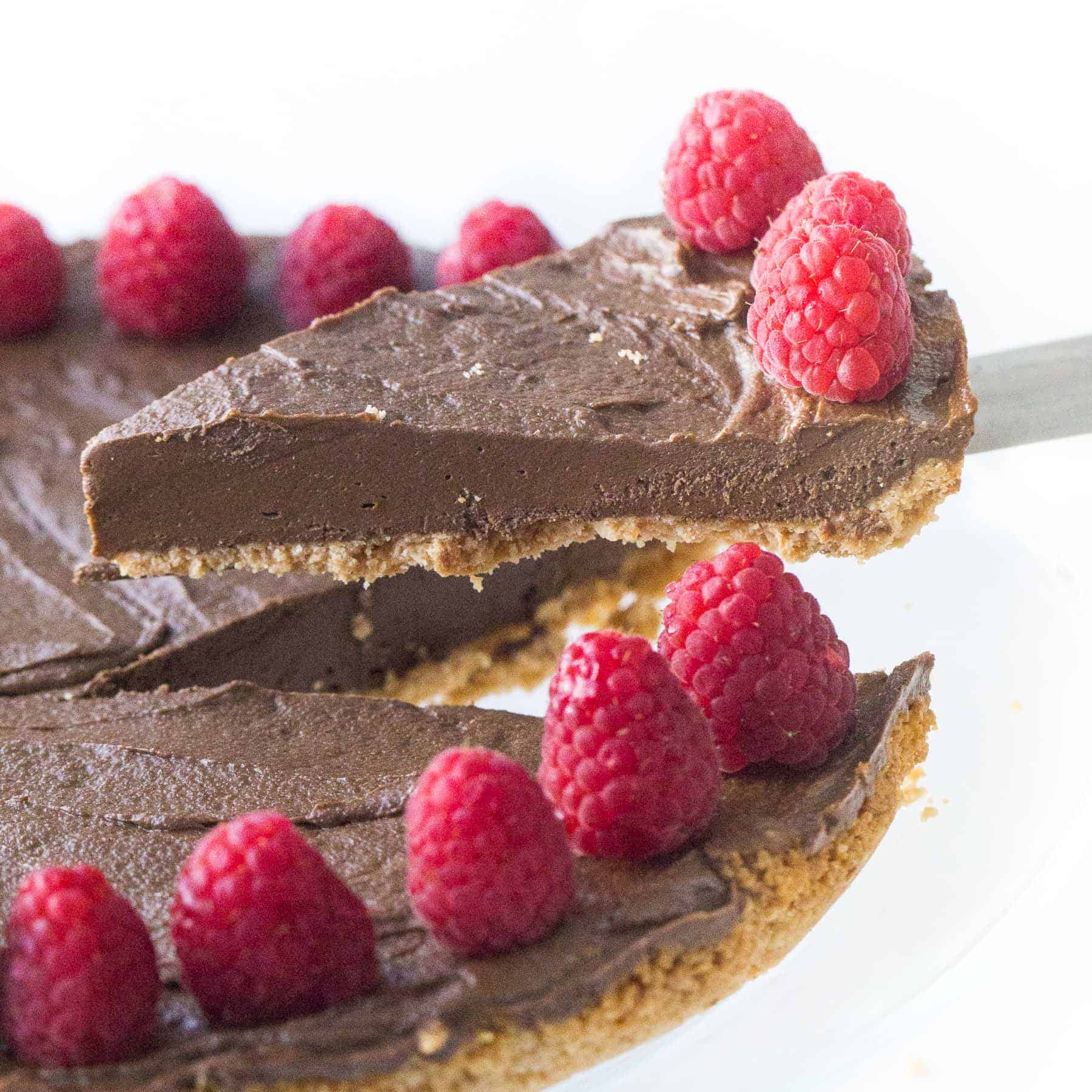 lifting a slice of healthy chocolate tart