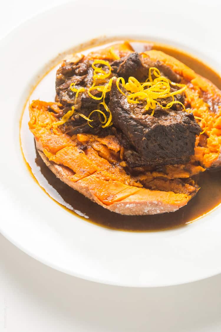 Slow cooker Moroccan Braised Short Ribs - tender, flavorful short ribs cooked in an orange cinnamon sauce, served over a baked sweet potato #paleo #whole30 #glutenfree #lowcarb