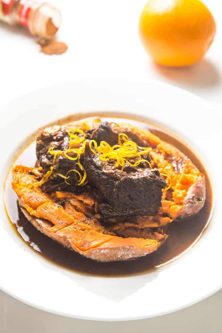 Slow cooker Moroccan Braised Short Ribs - tender, flavorful short ribs cooked in an orange cinnamon sauce, served over a baked sweet potato #paleo #whole30 #glutenfree #lowcarb