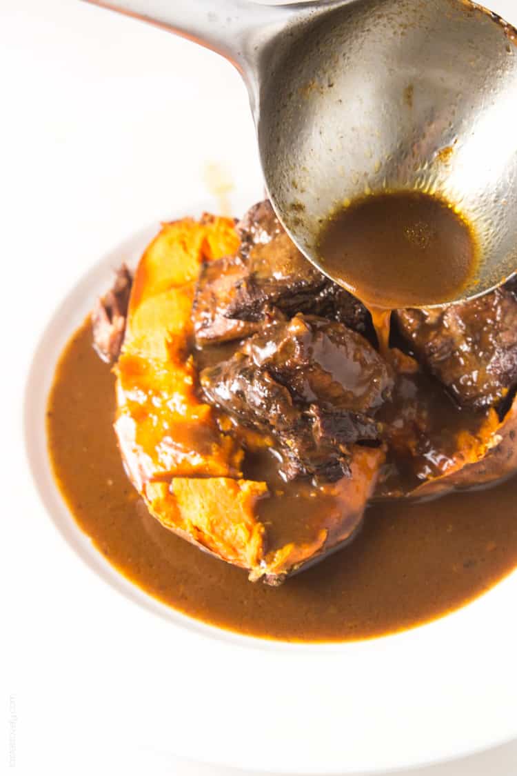 Slow cooker Moroccan Braised Short Ribs - tender, flavorful short ribs cooked in an orange cinnamon sauce, served over a baked sweet potato #paleo #whole30 #glutenfree #lowcarb