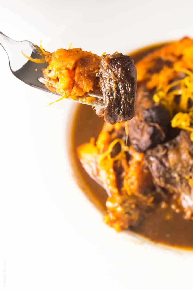 Slow cooker Moroccan Braised Short Ribs - tender, flavorful short ribs cooked in an orange cinnamon sauce, served over a baked sweet potato #paleo #whole30 #glutenfree #lowcarb
