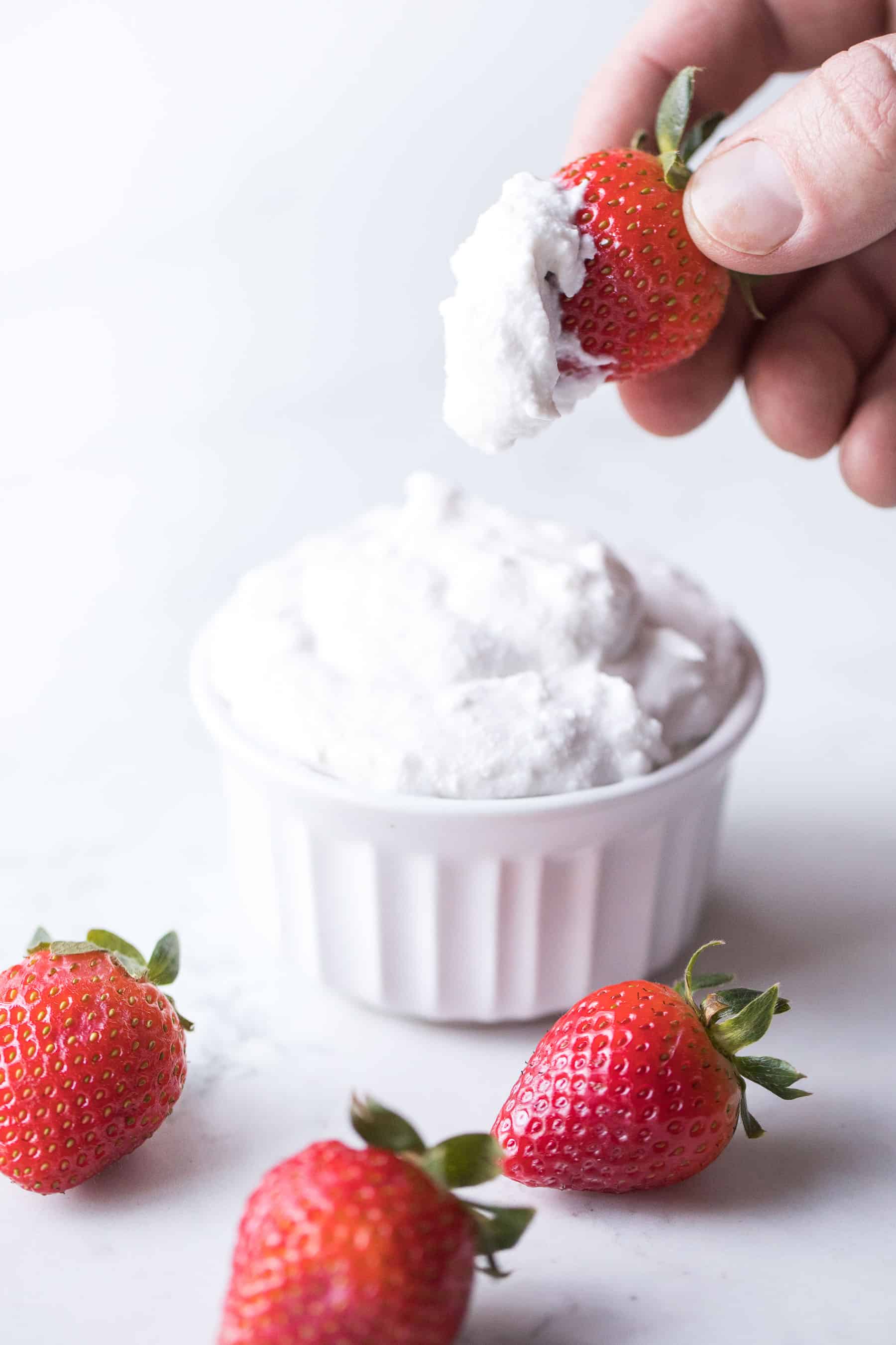 Strawberries dipped in coconut whipped cream