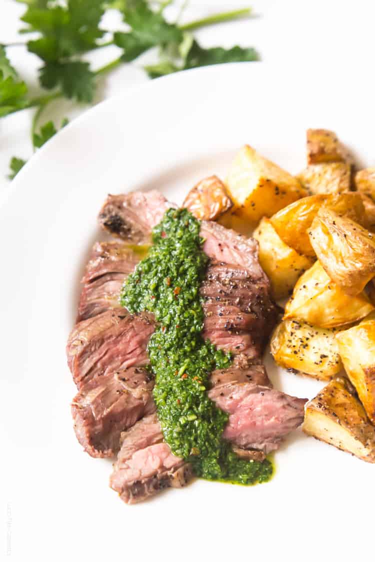 Skirt steak with chimichurri sauce - a delicious (and affordable!) steak dinner topped with a cilantro parsley mixture. #paleo #whole30 #glutenfree #lowcarb