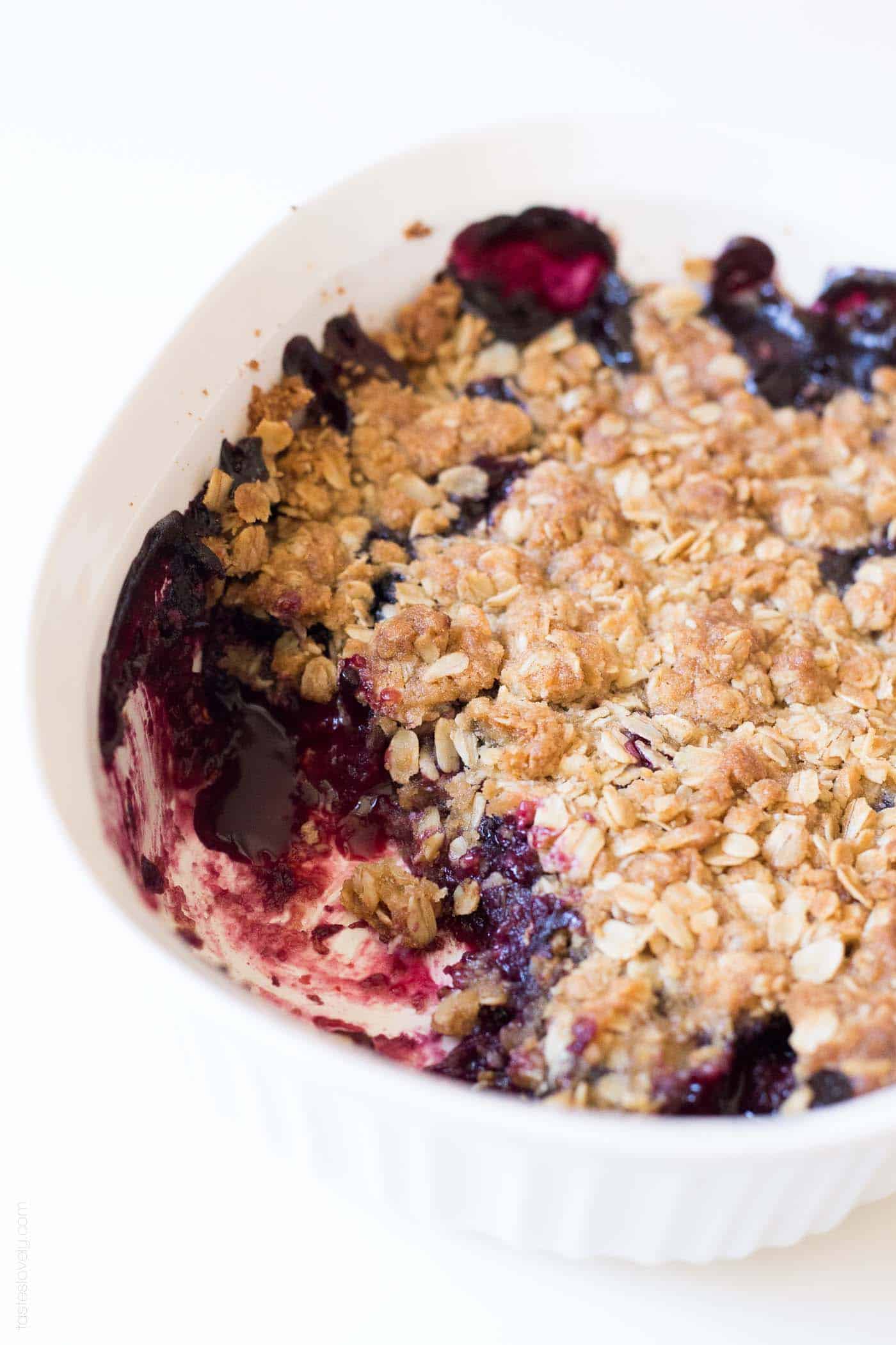 the easiest frozen berries dessert recipe: berry crumble with one scoop taken out