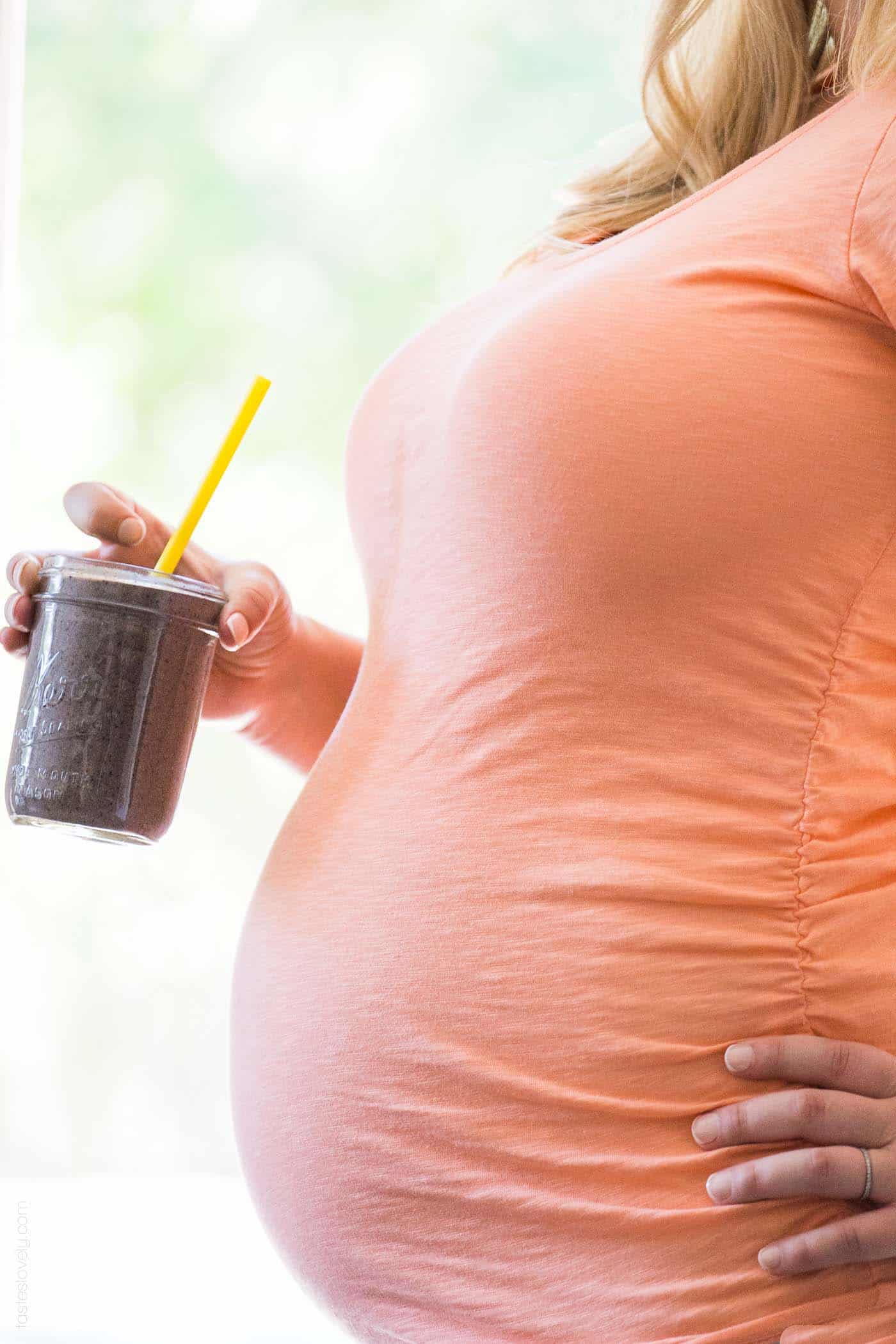 photo of pregnant woman holding a superfoods smoothie
