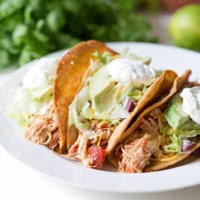 Slow Cooker Mexican Shredded Chicken Tacos - juicest and most delicious chicken tacos ever! (gluten free) | tasteslovely.com