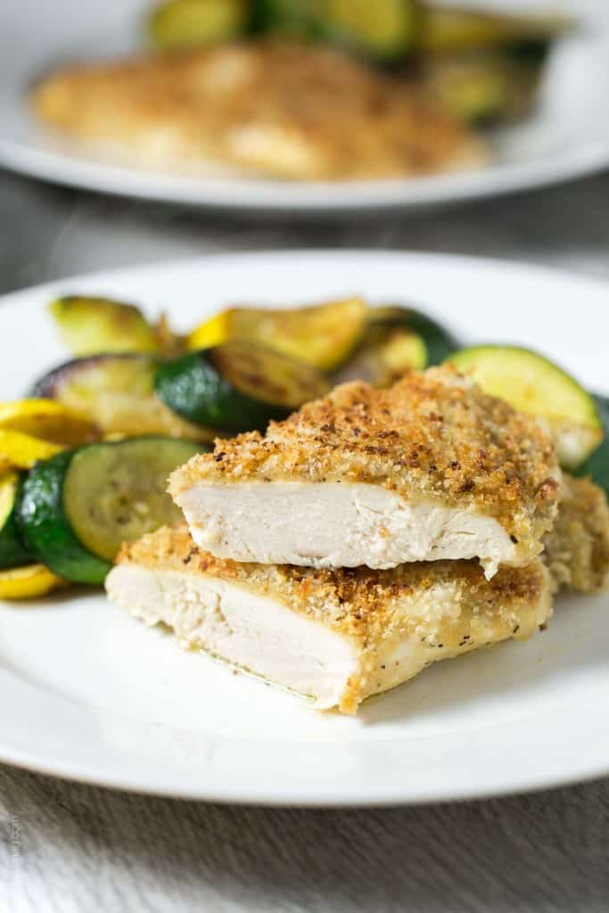 Crispy oven baked honey mustard chicken - chicken breasts smothered in honey mustard sauce, topped with panko bread crumbs, and baked in the oven until golden and crispy. The easiest 30 minute chicken dinner!