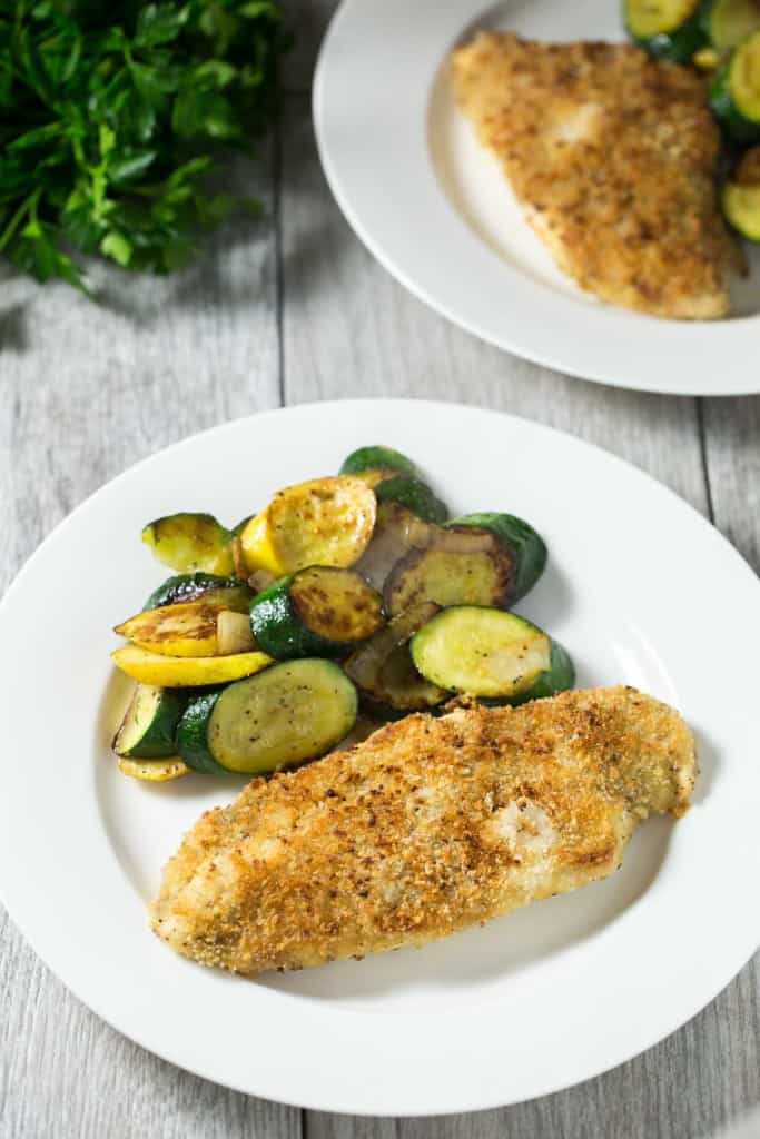 Crispy oven baked honey mustard chicken - chicken breasts smothered in honey mustard sauce, topped with panko bread crumbs, and baked in the oven until golden and crispy. The easiest 30 minute chicken dinner!