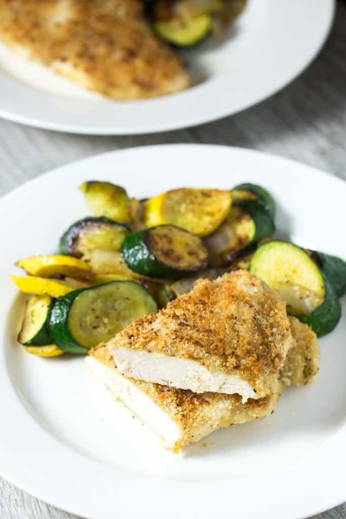 Crispy oven baked honey mustard chicken - chicken breasts smothered in honey mustard sauce, topped with panko bread crumbs, and baked in the oven until golden and crispy. The easiest 30 minute chicken dinner!