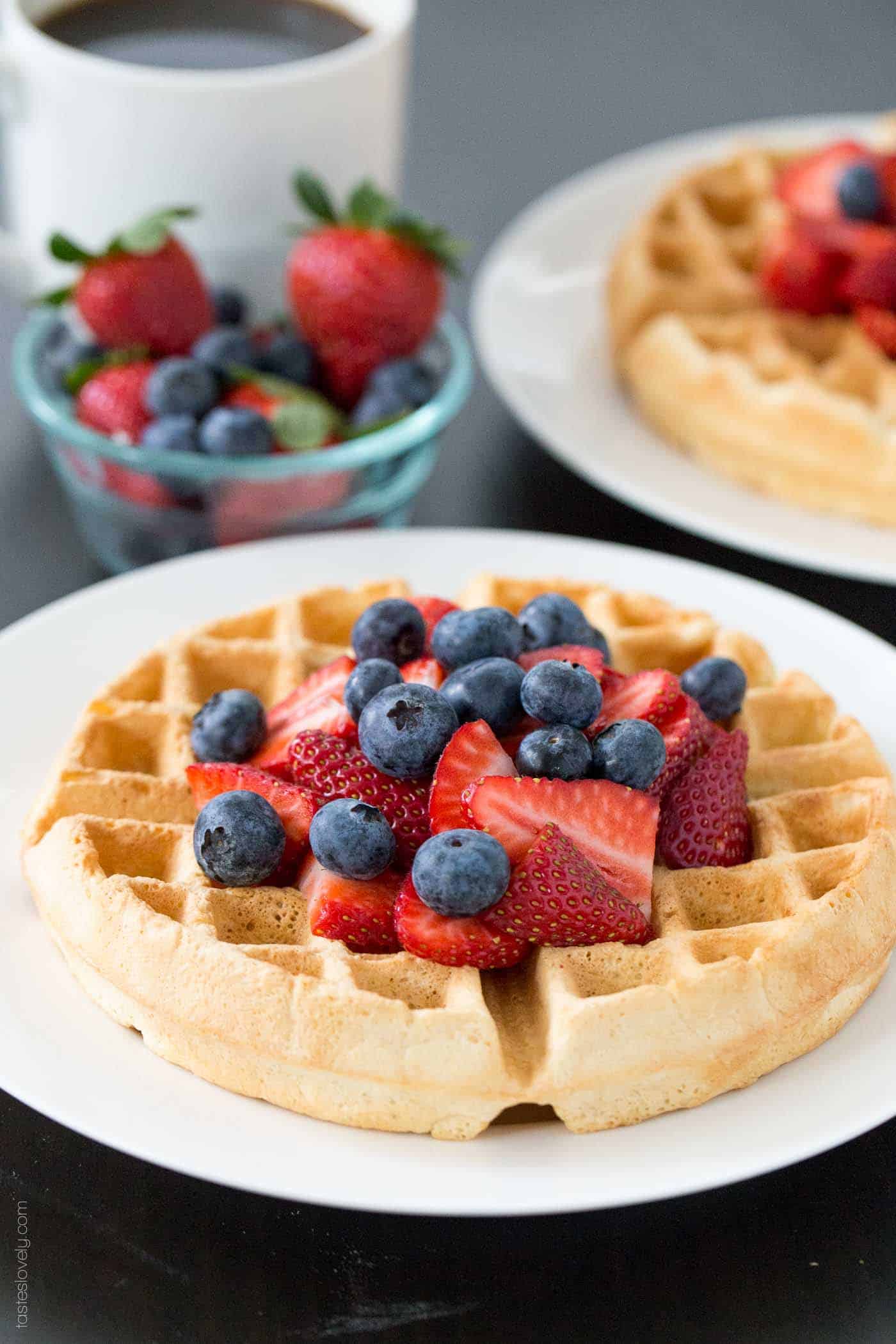 a photo of a single waffle topped with fresh berries