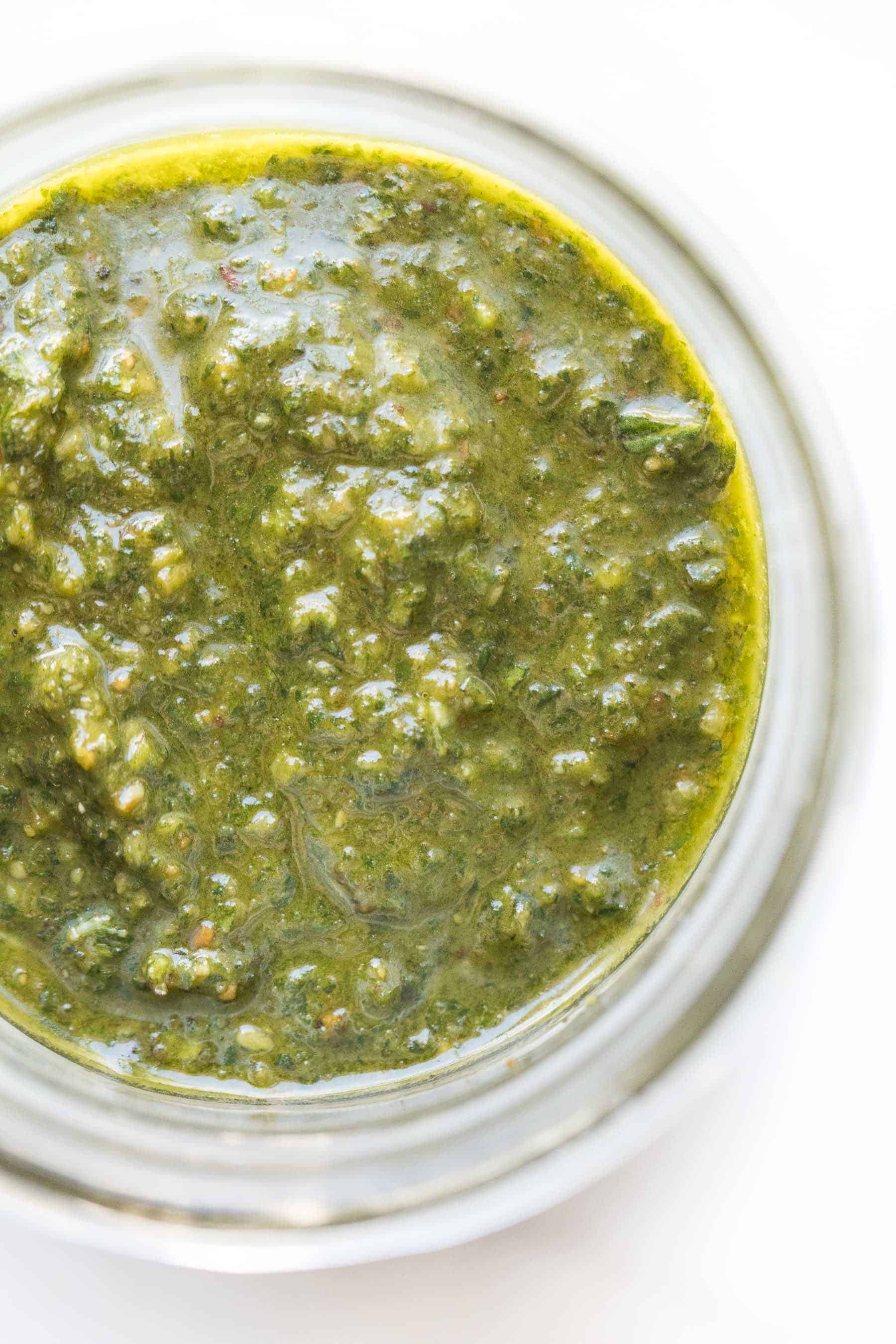 pesto in a mason jar on a white background