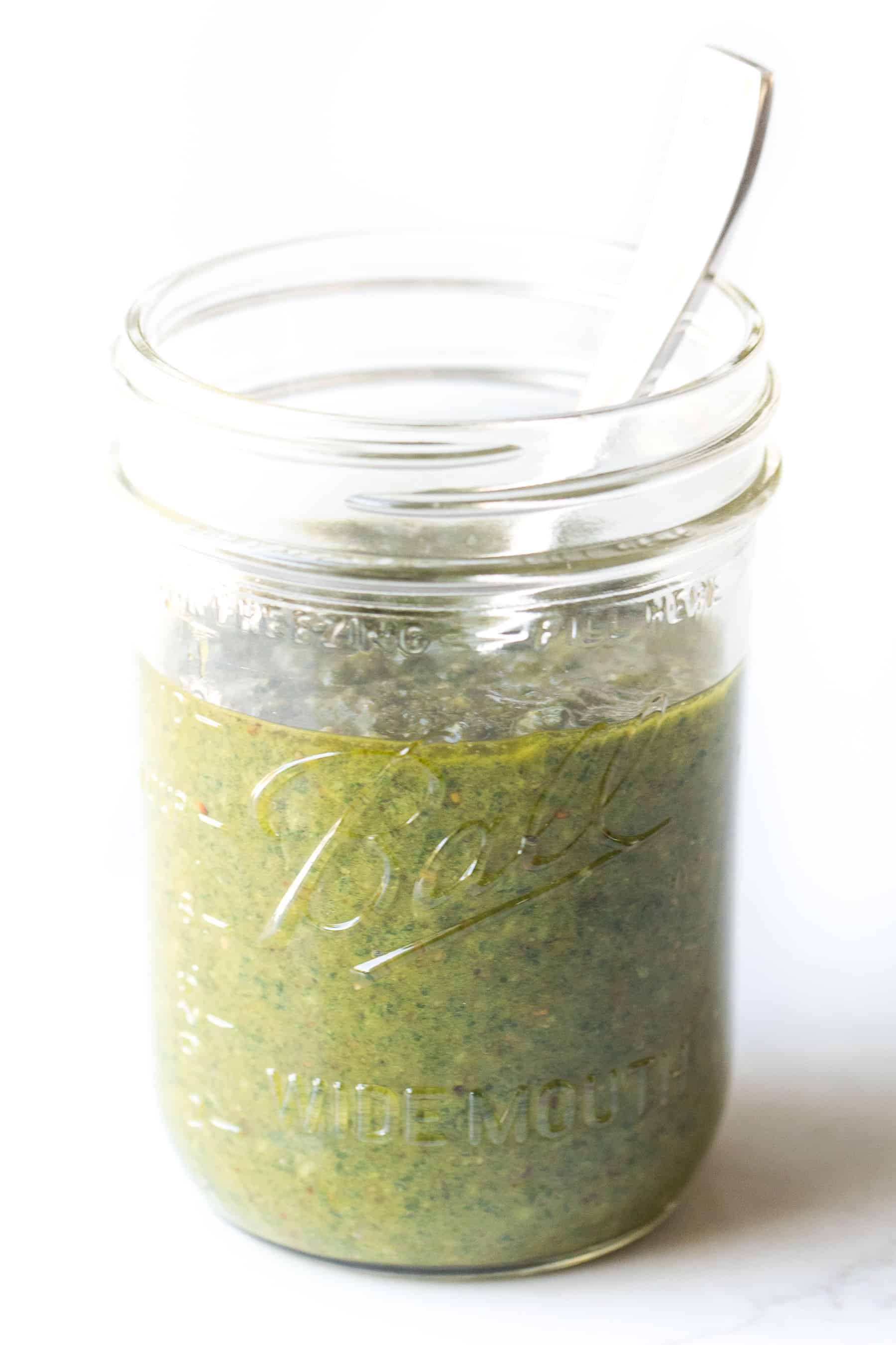 pesto in a mason jar on a white background