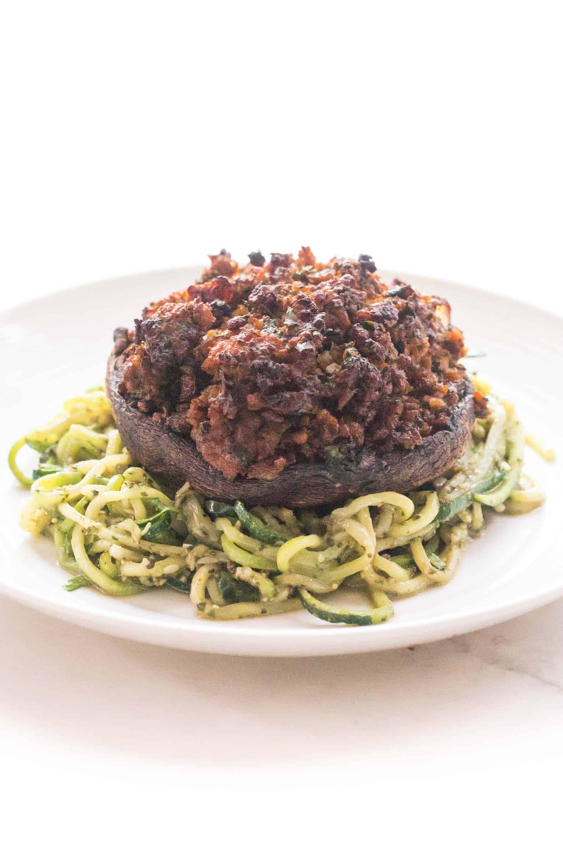 sausage stuffed portobello mushrooms over zucchini noodles