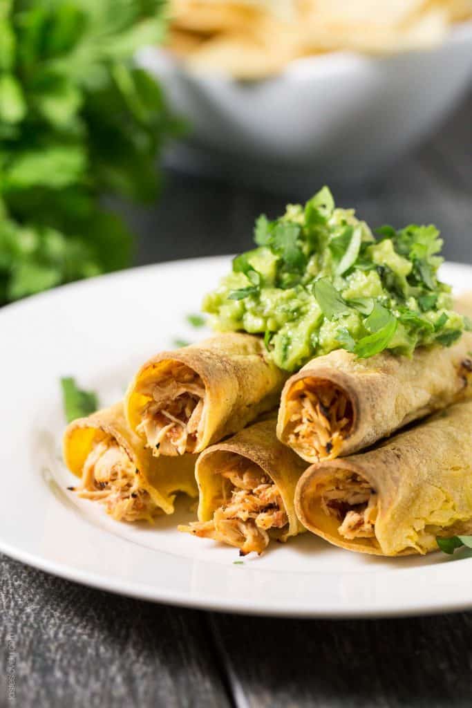 Baked Shredded Chicken Taquitos - juicy Mexican shredded chicken made in the slow cooker, then wrapped in corn tortillas, sprayed with olive oil, and baked in the oven. Great for an appetizer or dinner, and much healthier than fried!