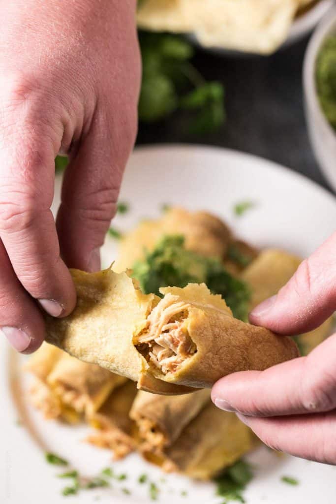 Baked Shredded Chicken Taquitos - juicy Mexican shredded chicken made in the slow cooker, then wrapped in corn tortillas, sprayed with olive oil, and baked in the oven. Great for an appetizer or dinner, and much healthier than fried!