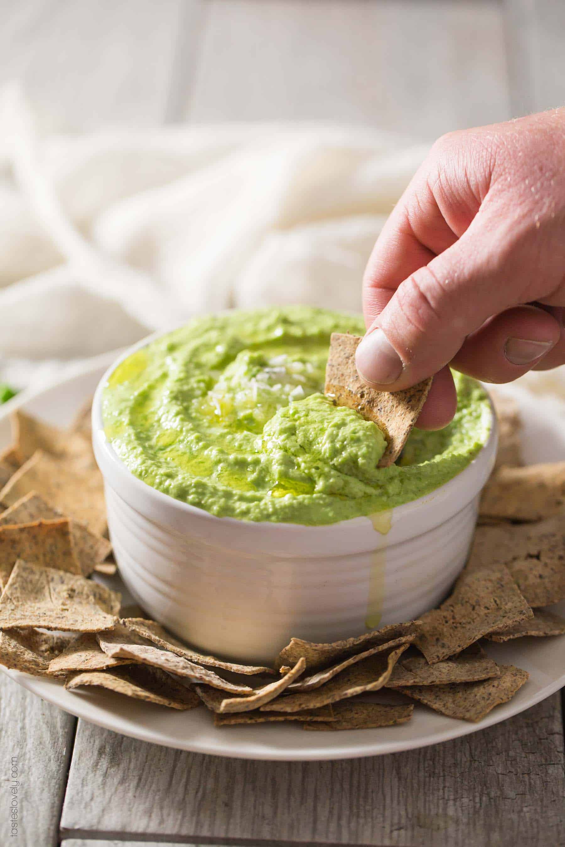 Paleo Sweet Pea No-Bean Hummus - a healthy spring appetizer served with my paleo almond pulp crackers. Paleo, gluten free, grain free, dairy free, sugar free.