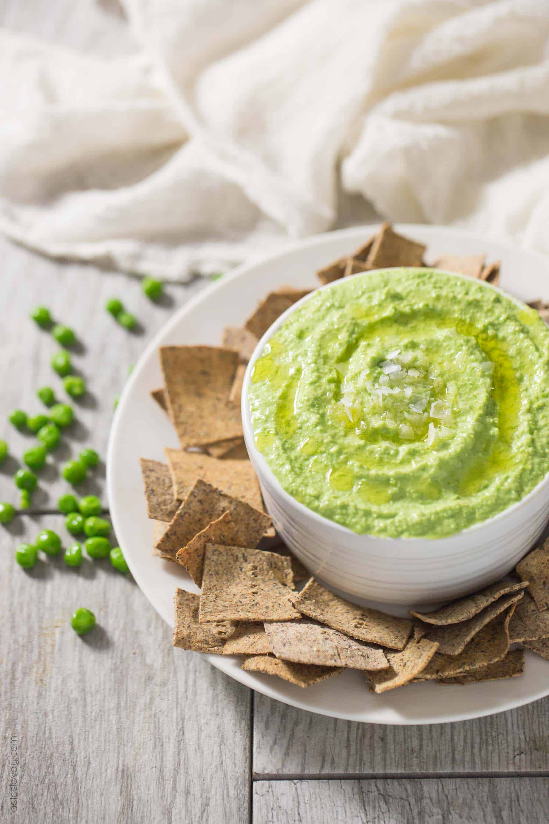 Paleo Sweet Pea No-Bean Hummus - a healthy spring appetizer served with my paleo almond pulp crackers. Paleo, gluten free, grain free, dairy free, sugar free.