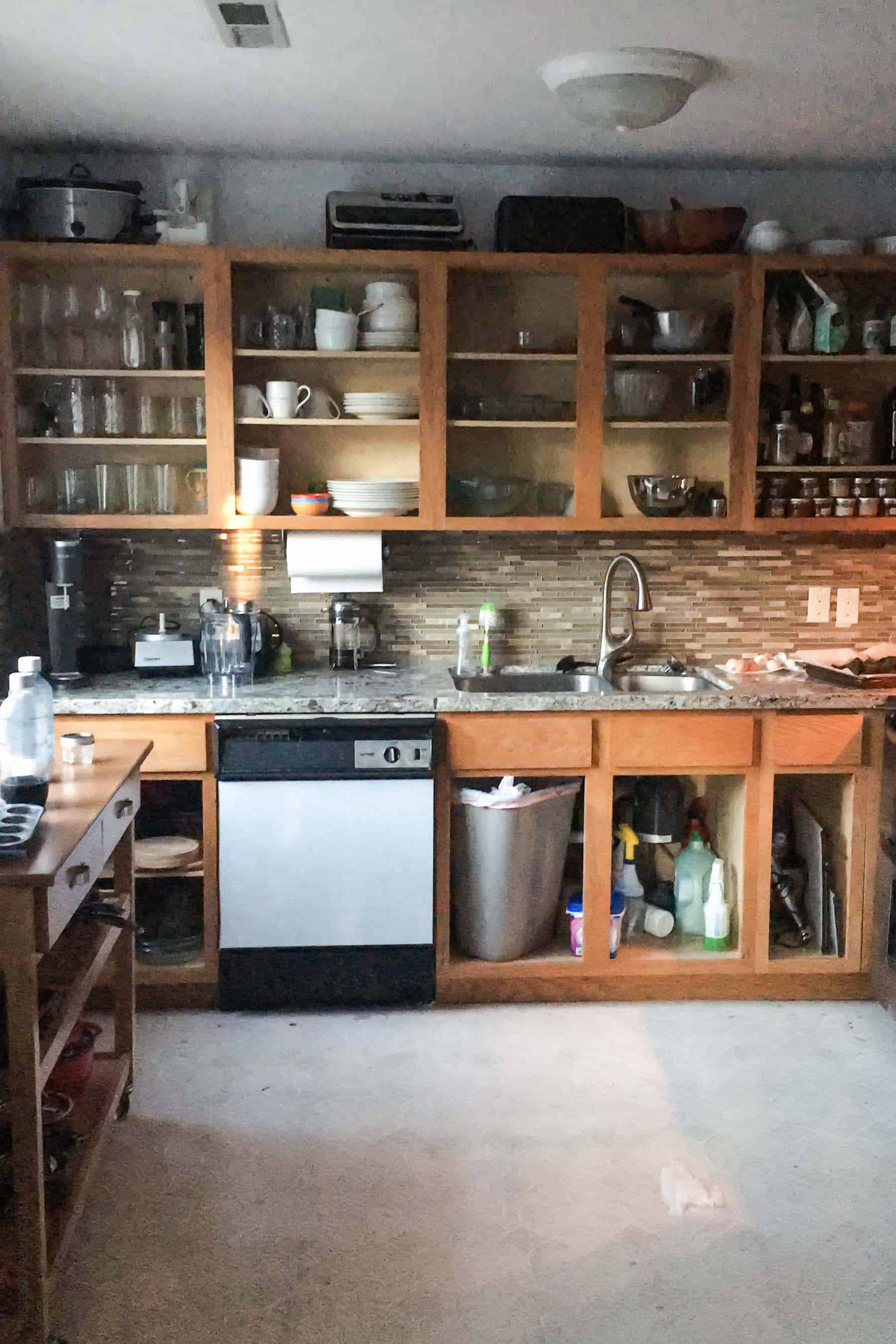 Our $281 DIY Kitchen Remodel - DIY painting oak cabinets white, adding wood trim to make shaker style cabinets, and adding hardware