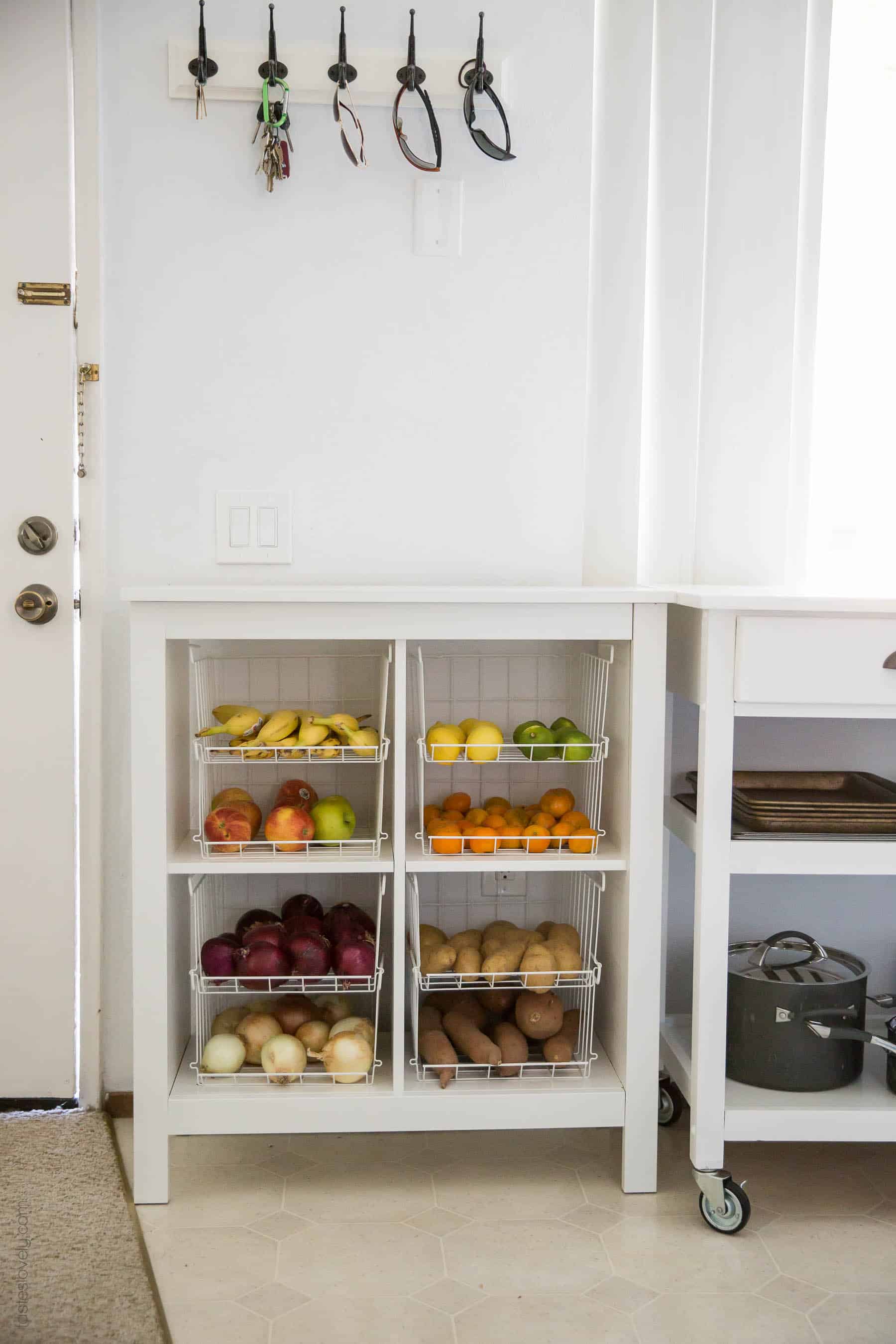 Our $281 DIY Kitchen Remodel - DIY painting oak cabinets white, adding wood trim to make shaker style cabinets, and adding hardware