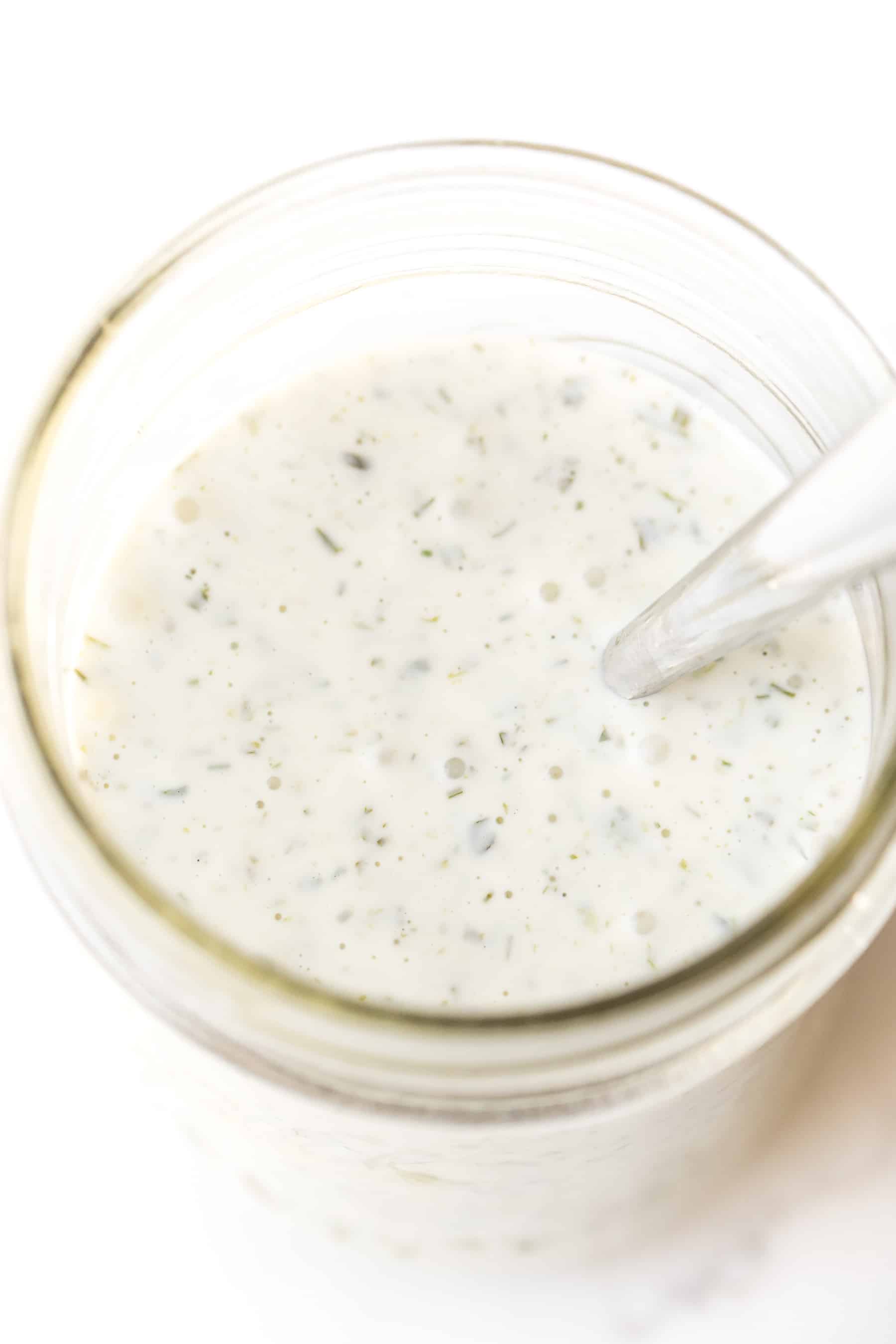 a jar of ranch dressing on a white background