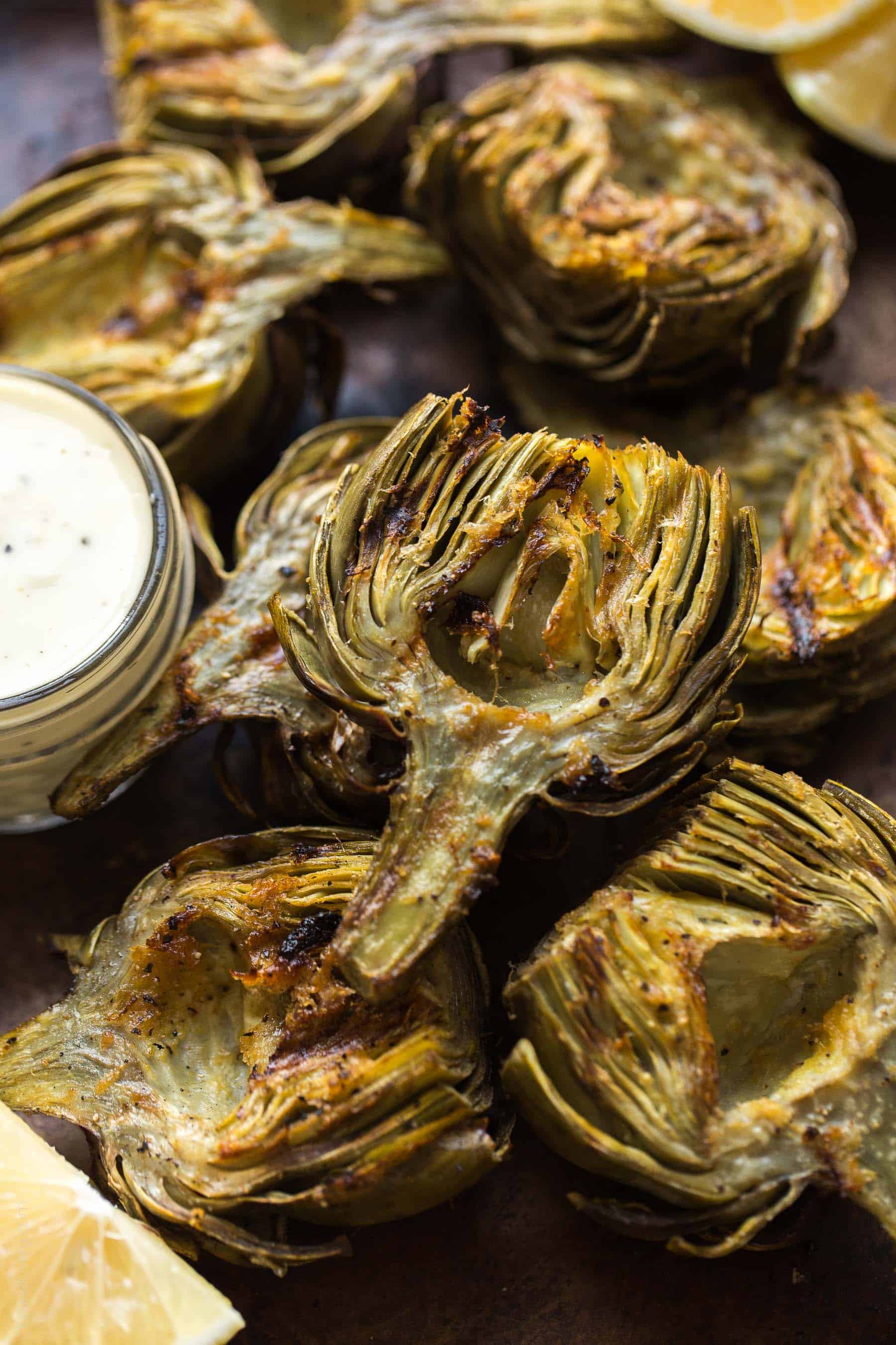 Paleo & Whole30 Grilled Artichokes with a lemon garlic basting oil and a lemon garlic aioli dipping sauce. A delicious appetizer or side dish recipe! Paleo, Whole30, gluten free, grain free, dairy free, sugar free, vegetarian, clean eating.