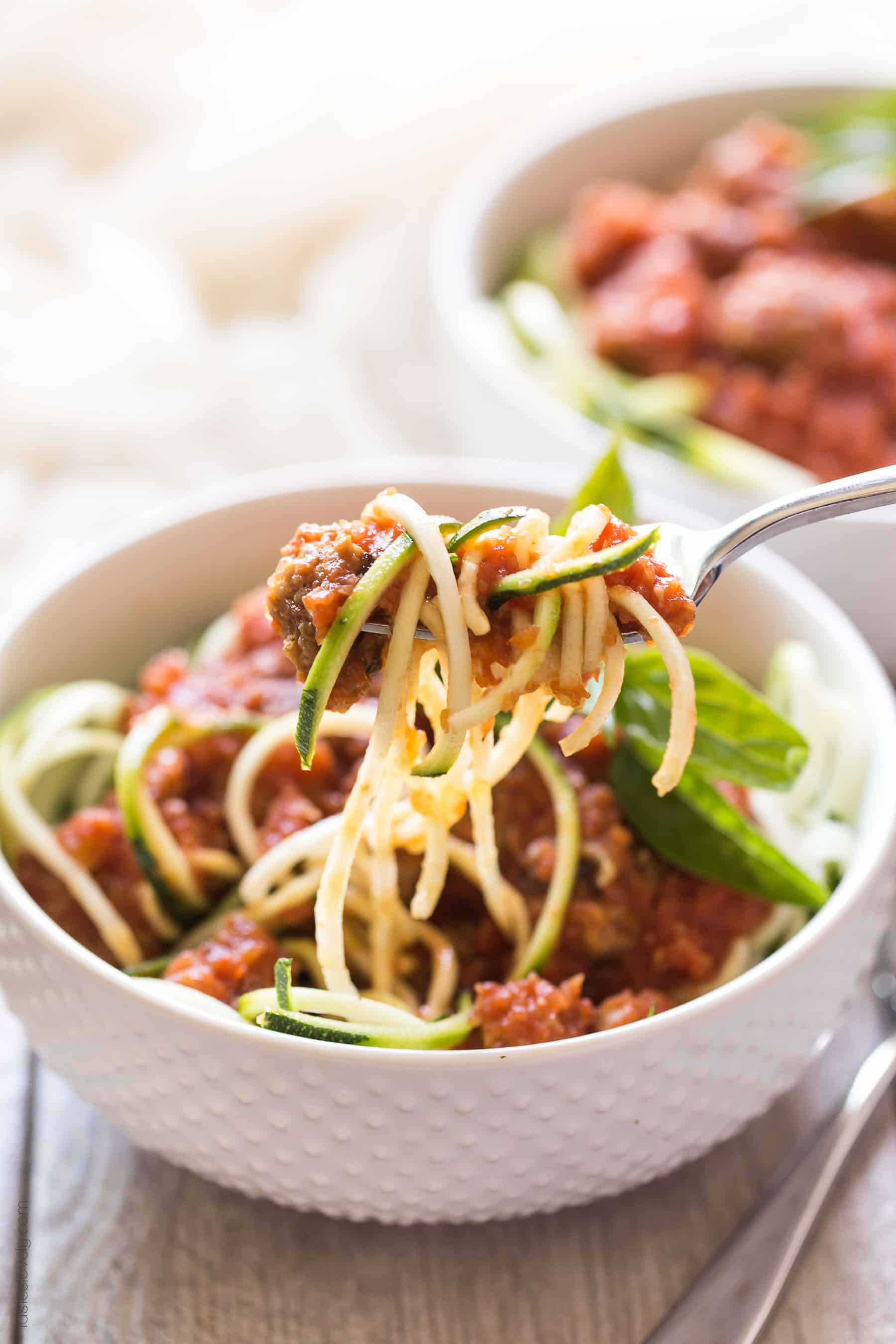 Homemade paleo & Whole30 marinara sauce, made from canned tomatoes with italian sausage. Served over zucchini noodles. A healthy and delicious dinner recipe! Paleo, whole30, gluten free, grain free, dairy free, sugar free, clean eating.