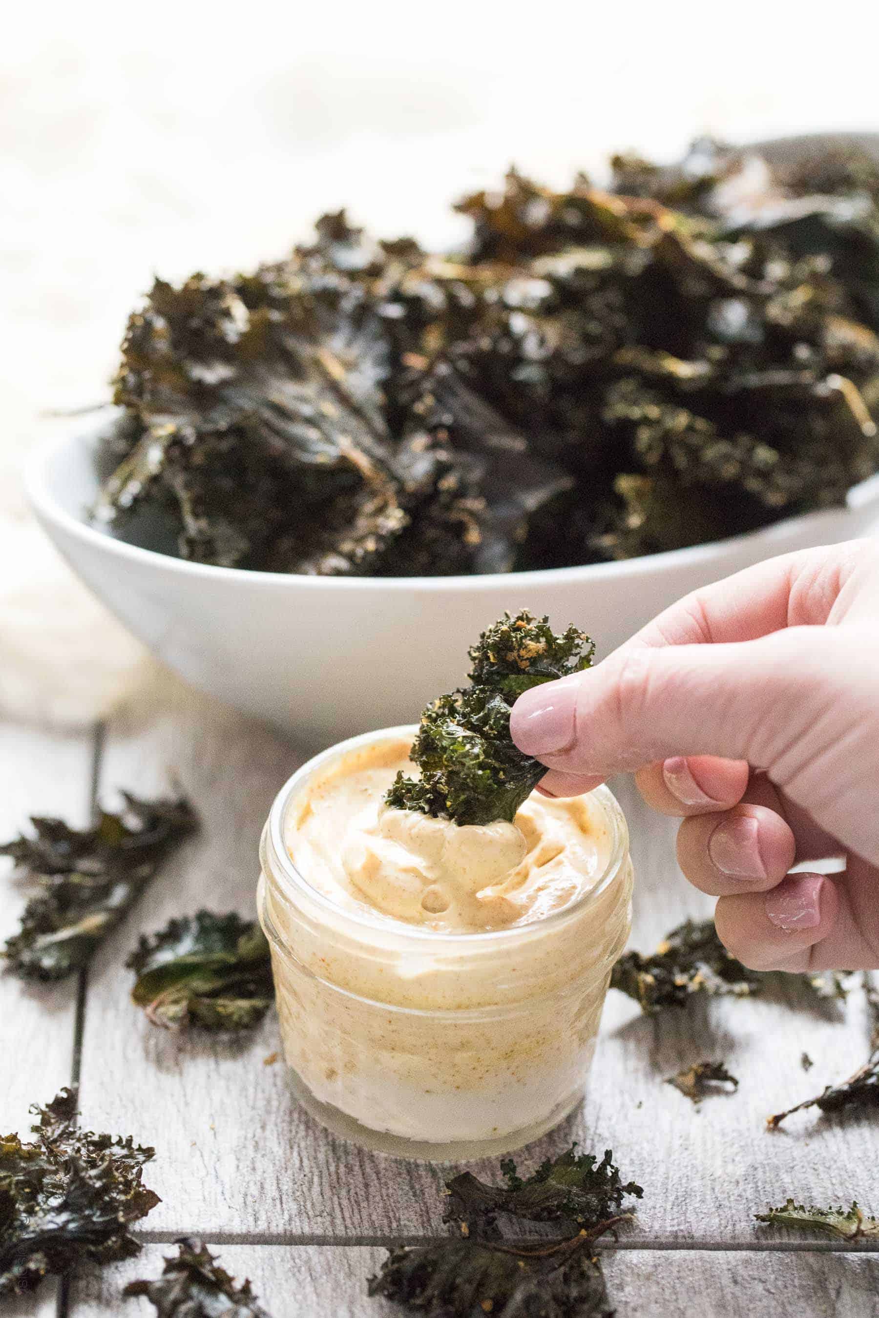 Roasted Kale Chips with Curry Aioli - a crispy, crunchy salty snack that is Paleo & Whole30. Ready in 20 minutes. Served with a curry aioli dipping sauce.