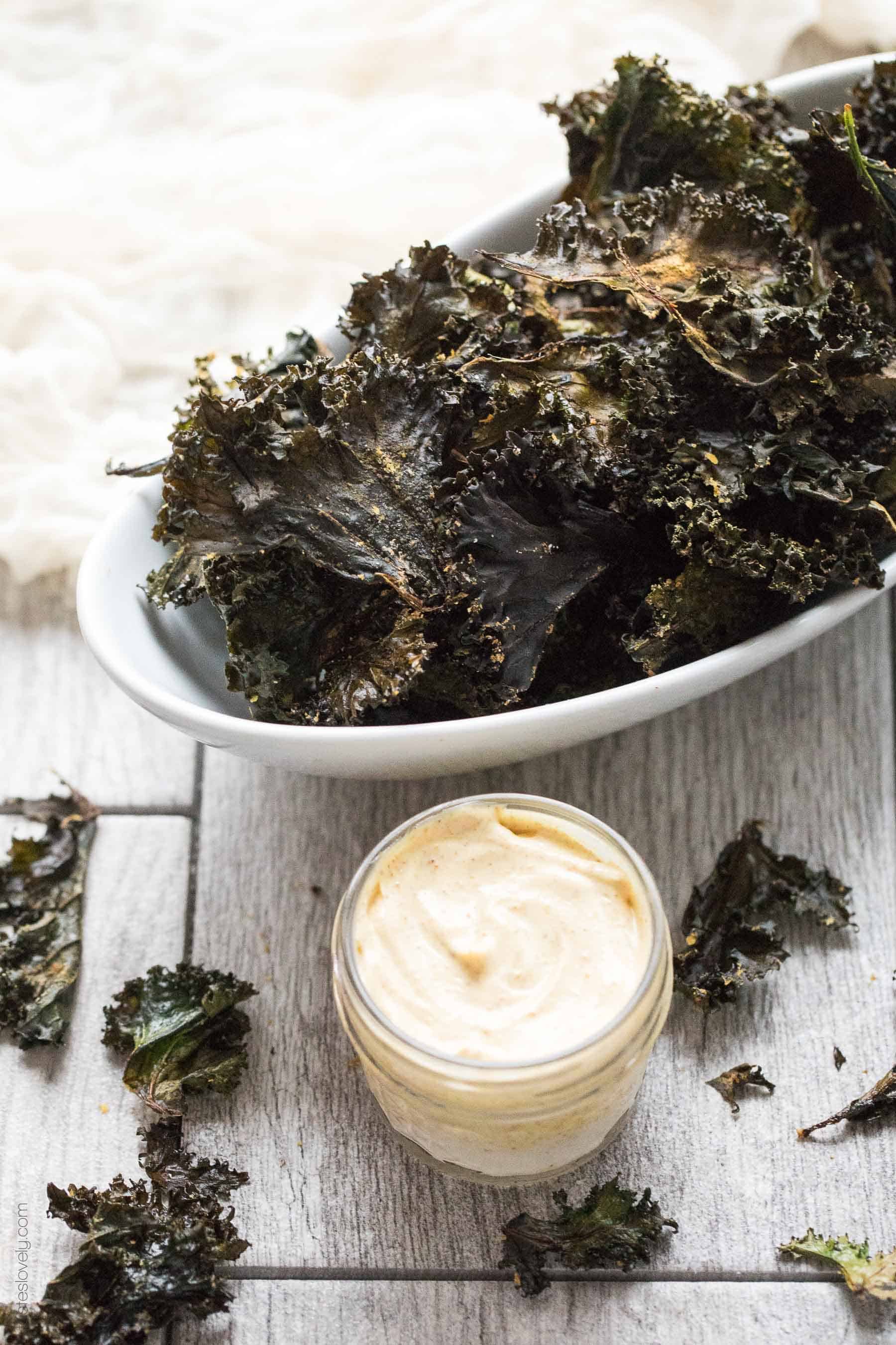 Roasted Kale Chips with Curry Aioli - a crispy, crunchy salty snack that is Paleo & Whole30. Ready in 20 minutes. Served with a curry aioli dipping sauce.