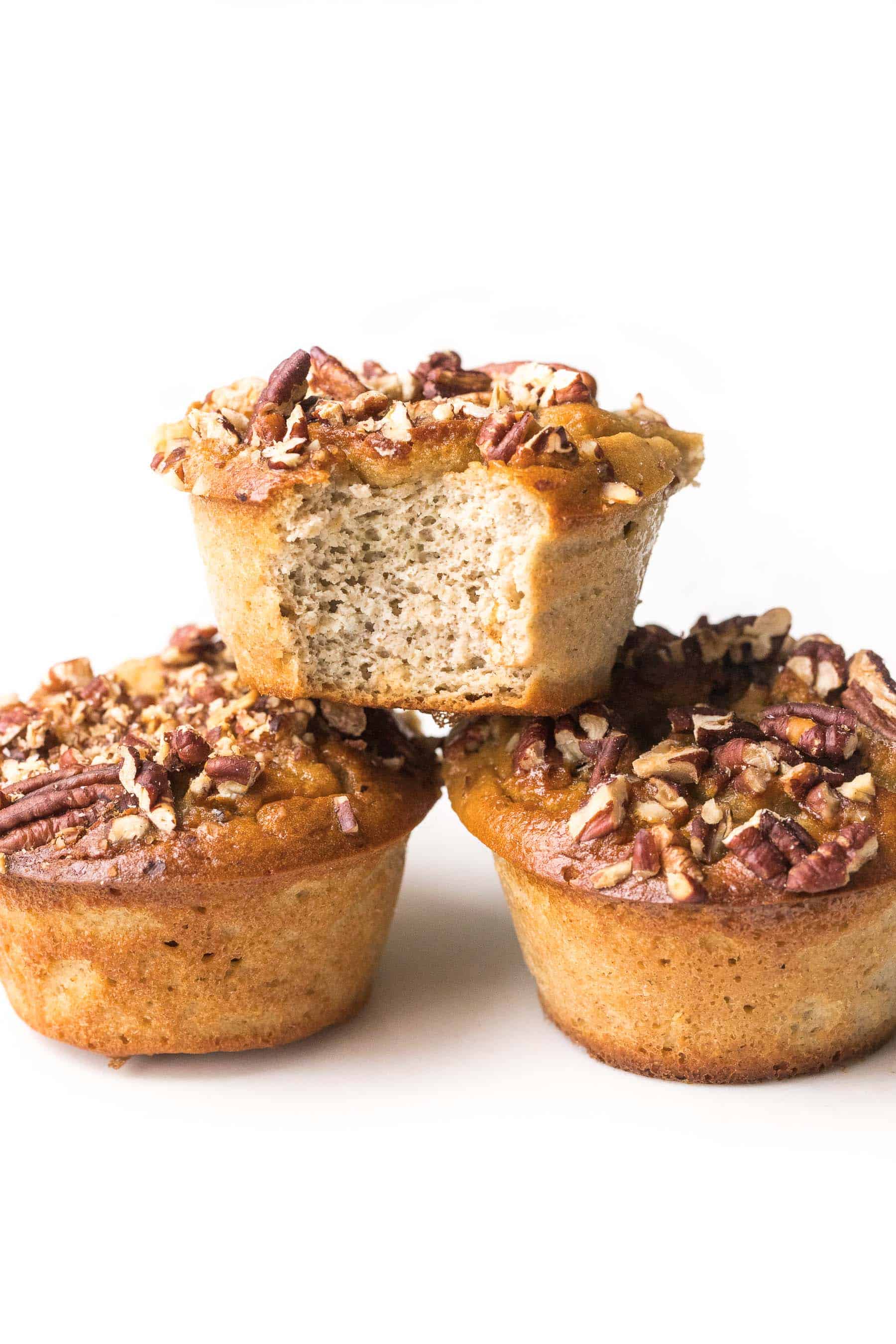 Stacked banana muffins on a white background