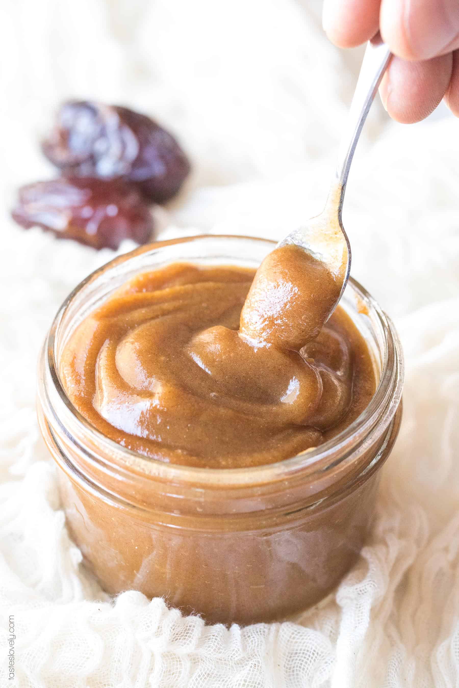 A spoon in a jar of date paste