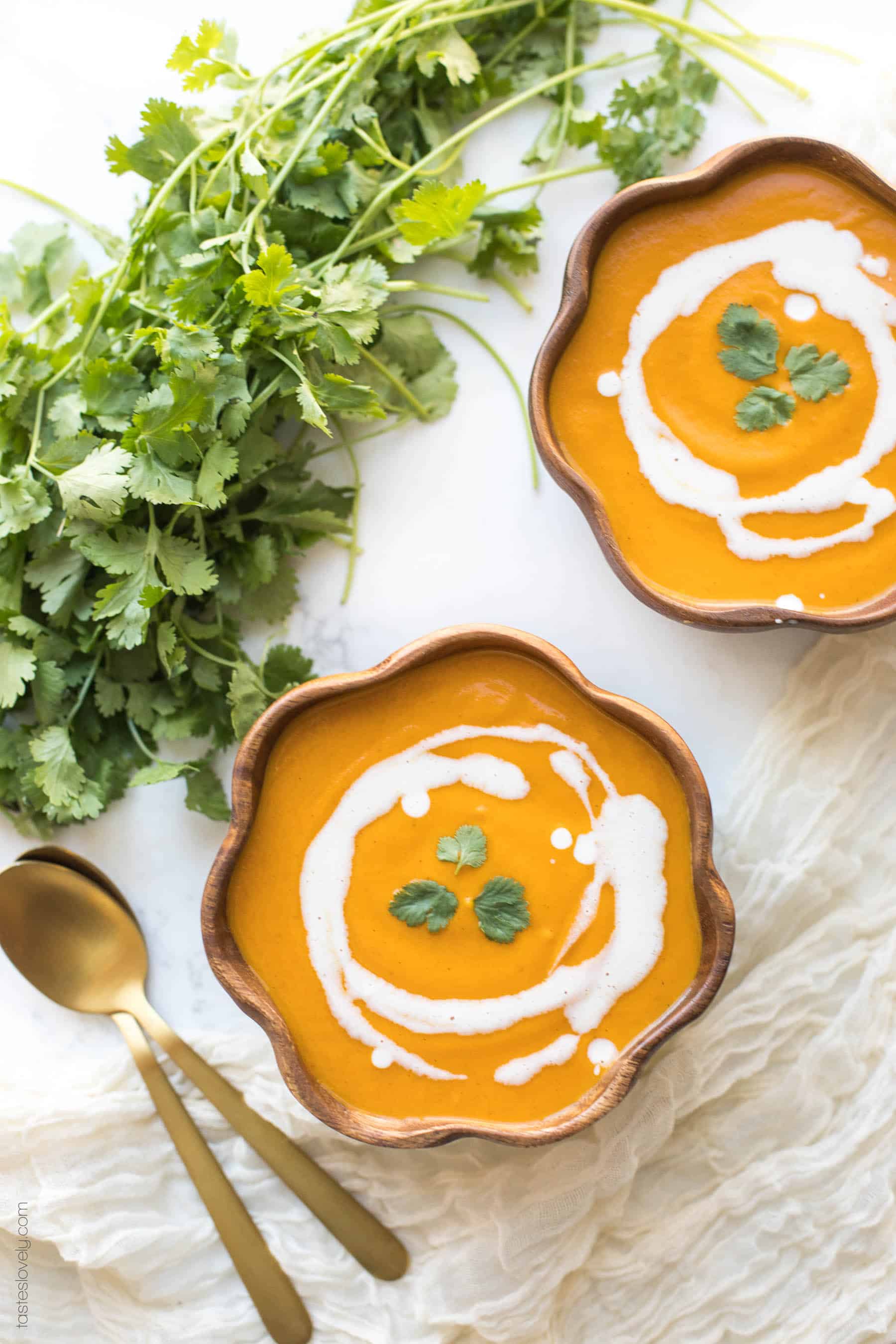 2 bowls of butternut squash soup with cilantro garnish