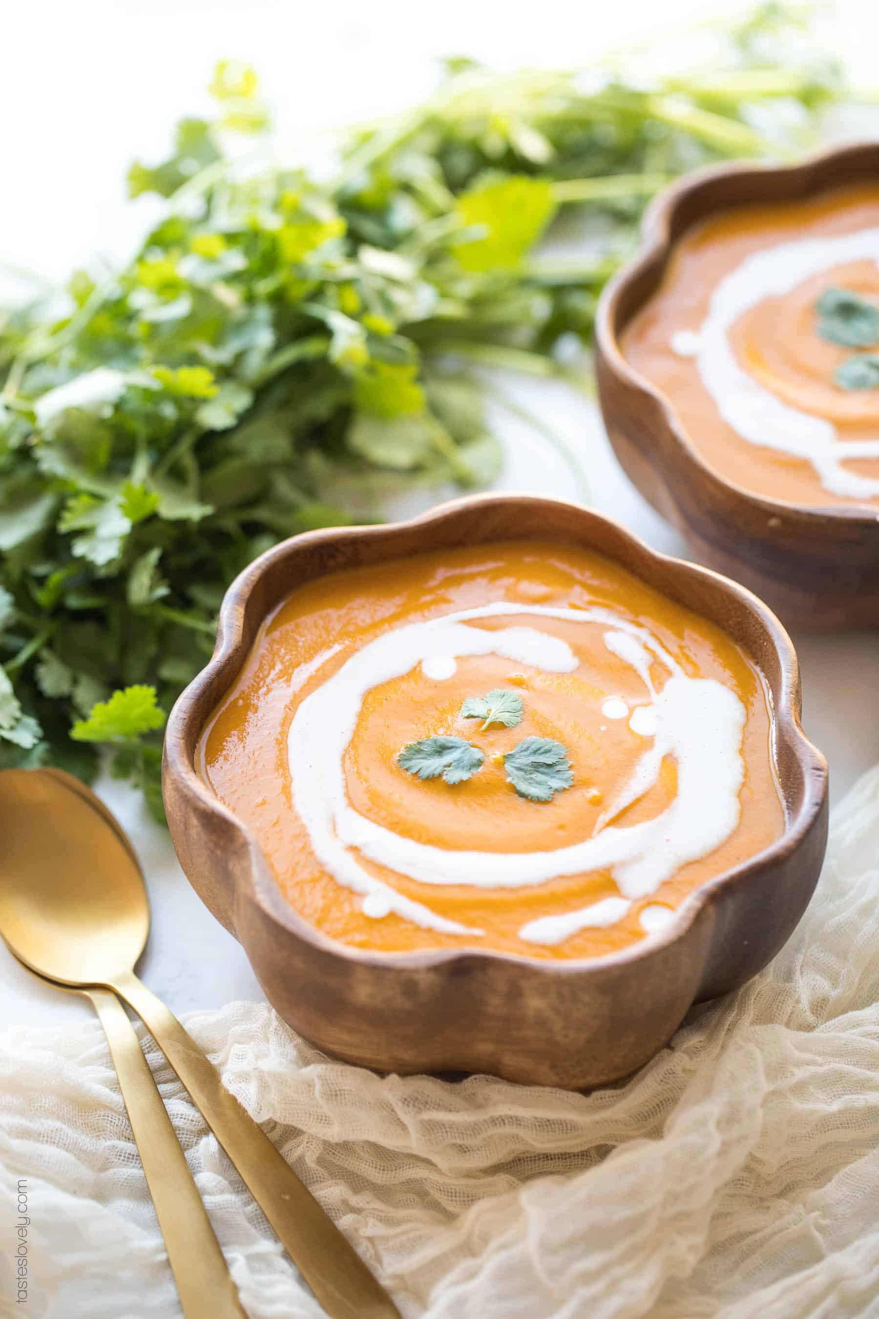 2 bowls of butternut squash soup with cilantro garnish