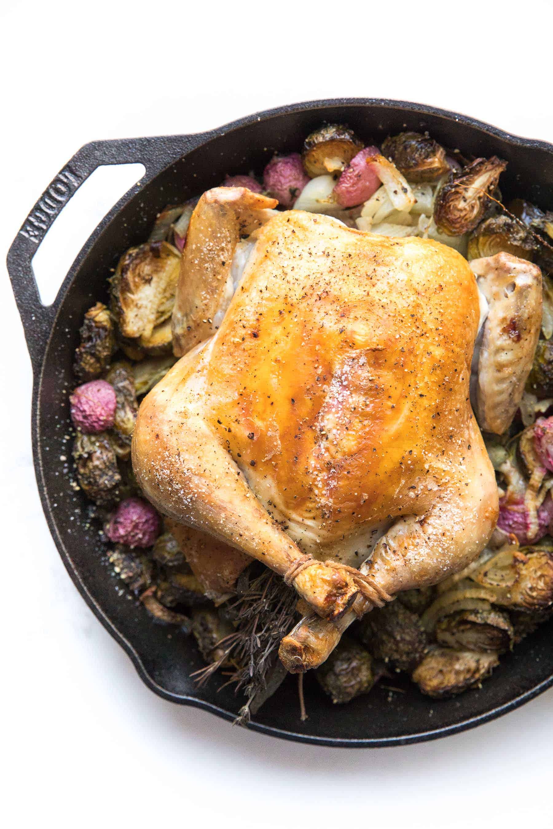 Roast chicken in a cast iron skillet with root vegetables