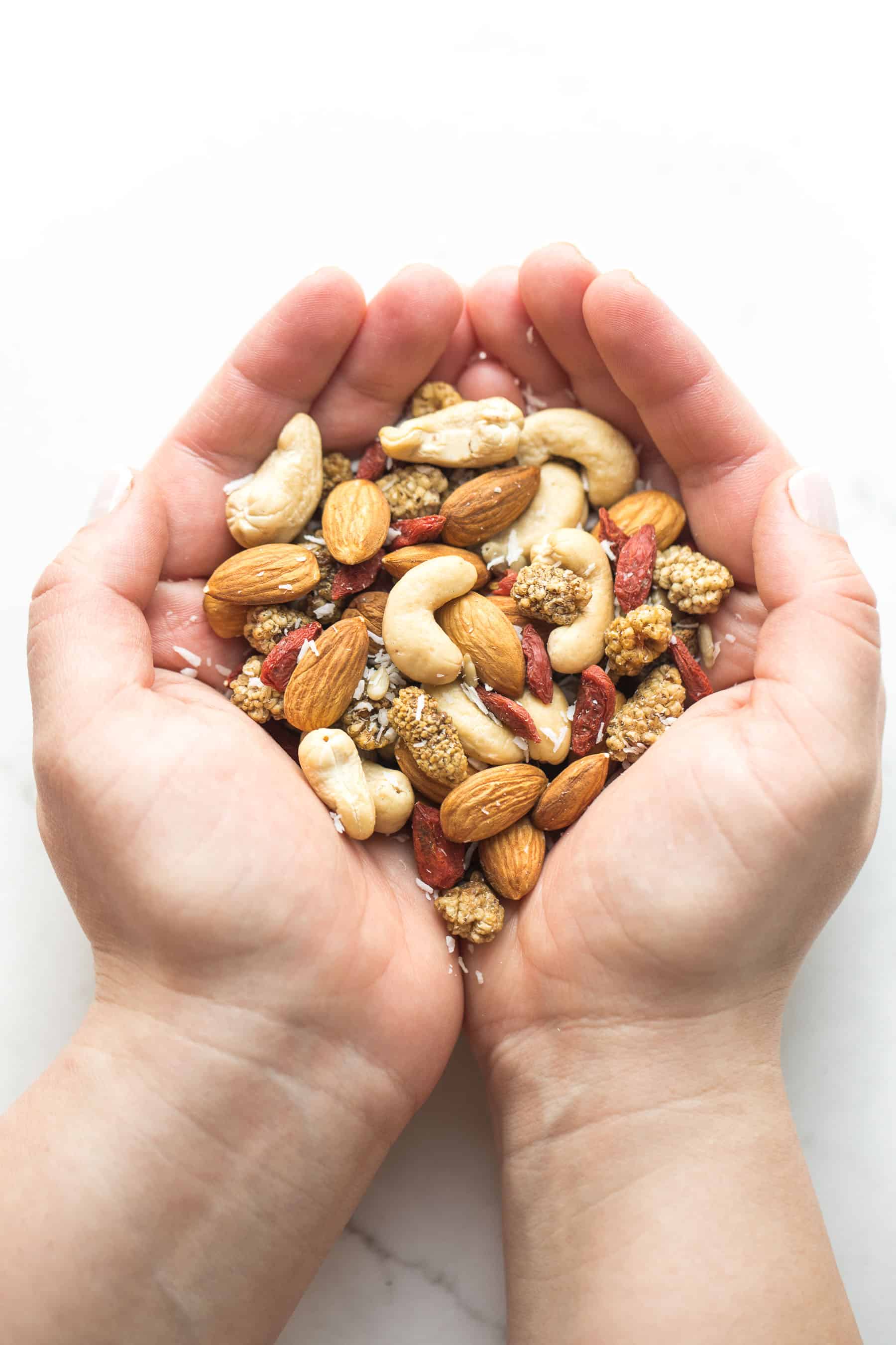 hand holding mixed berries and nuts