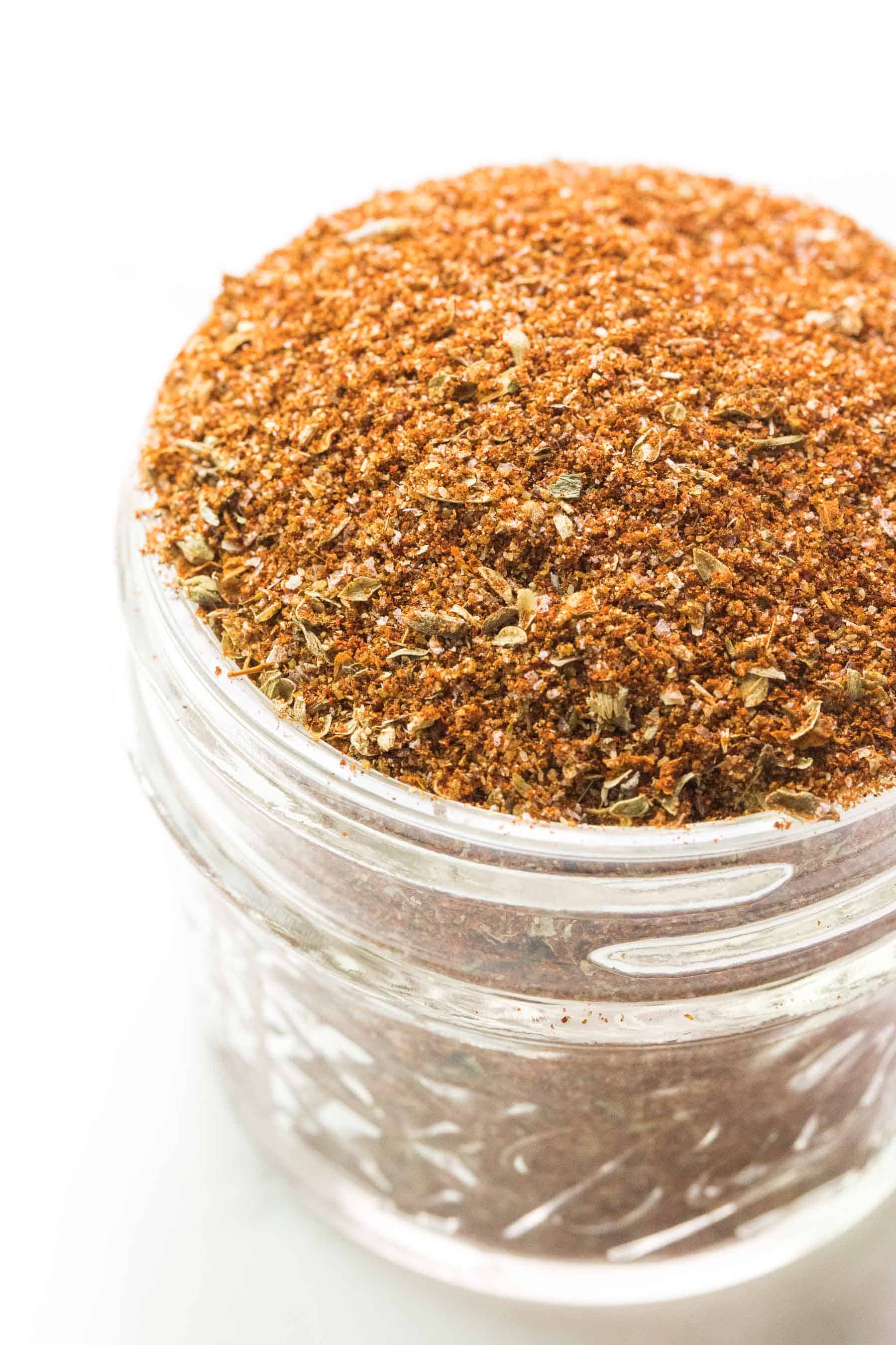 taco seasoning in a small mason jar on a white background