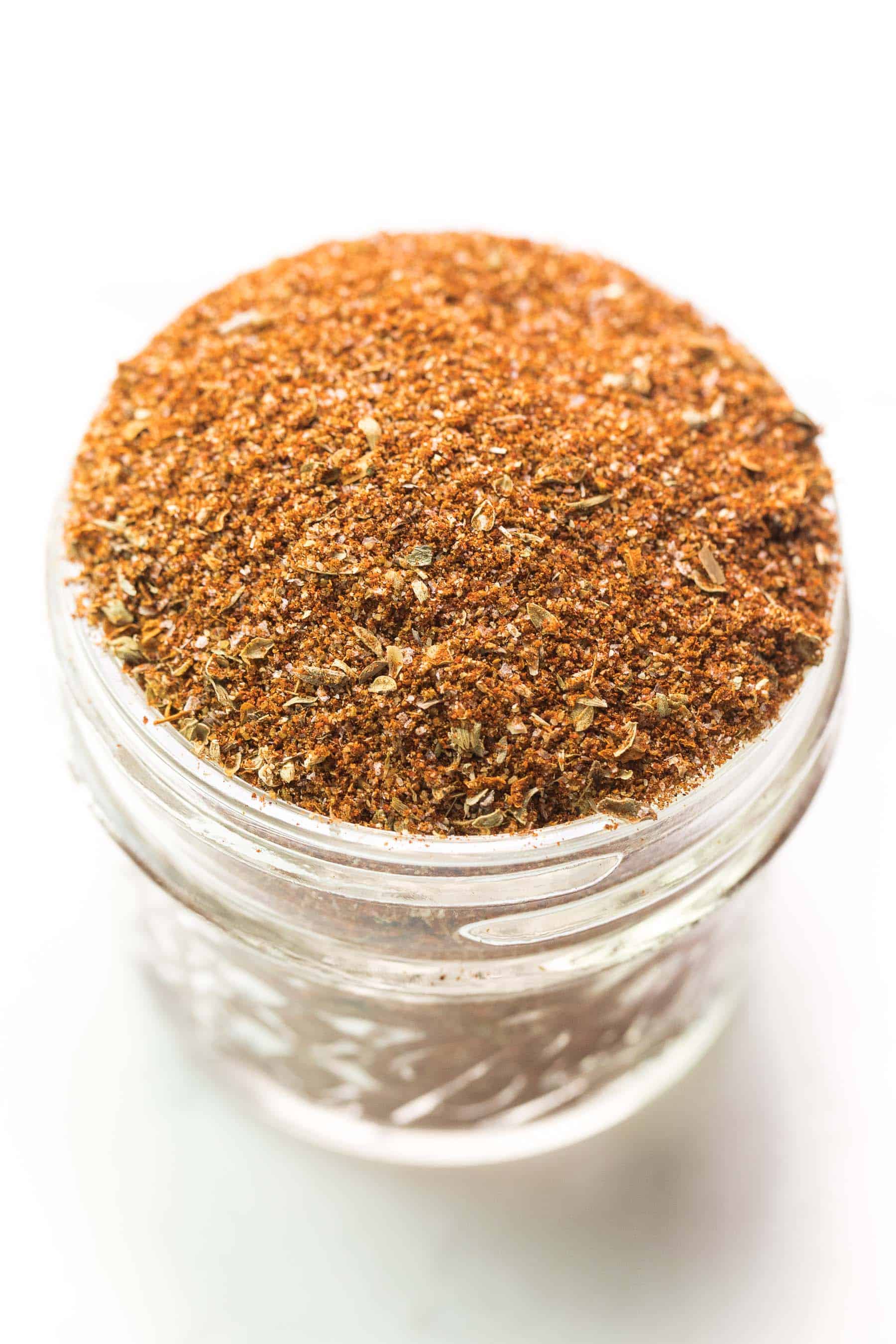 taco seasoning in a small mason jar on a white background