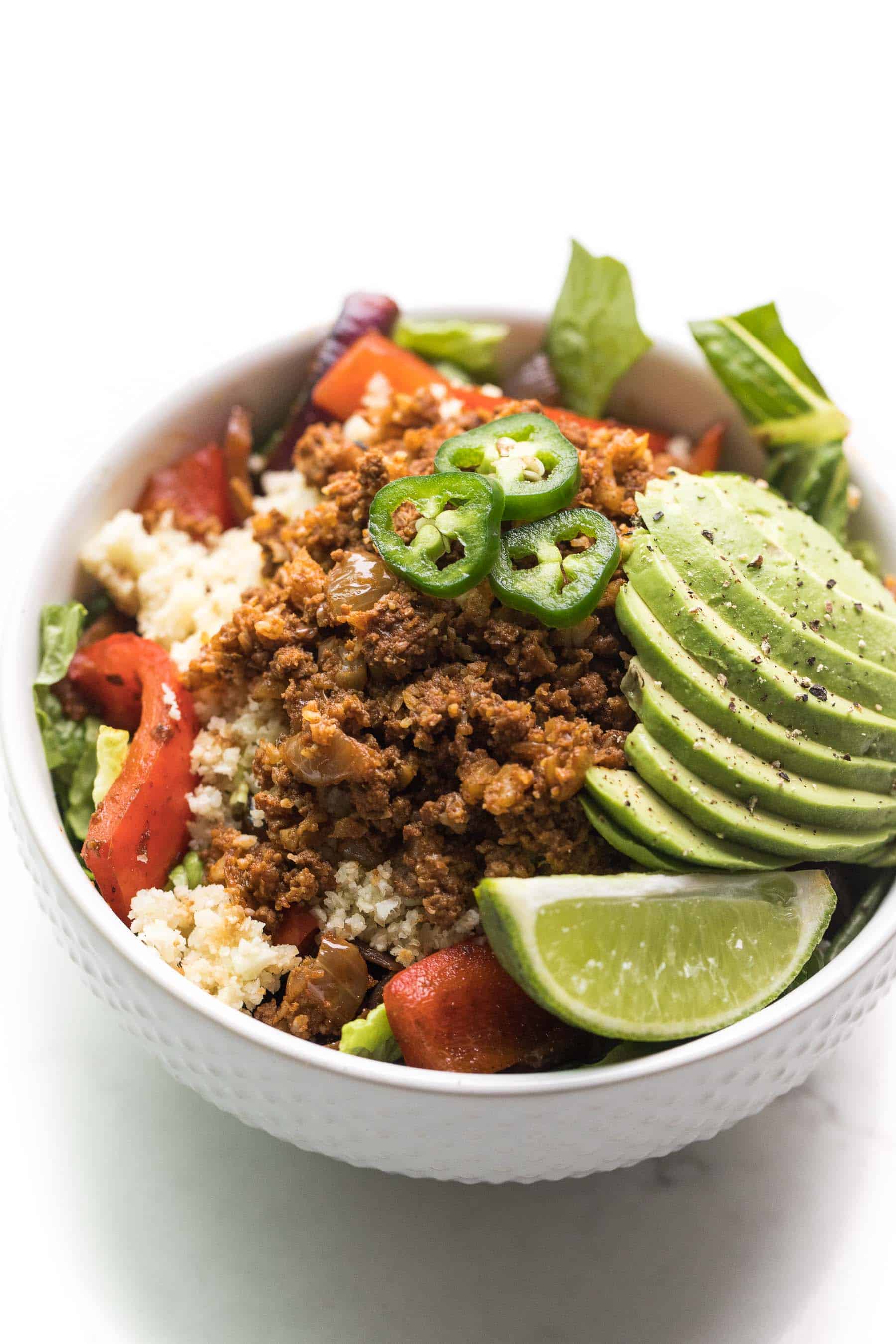 beef burrito taco bowl in a white bowl on a white background