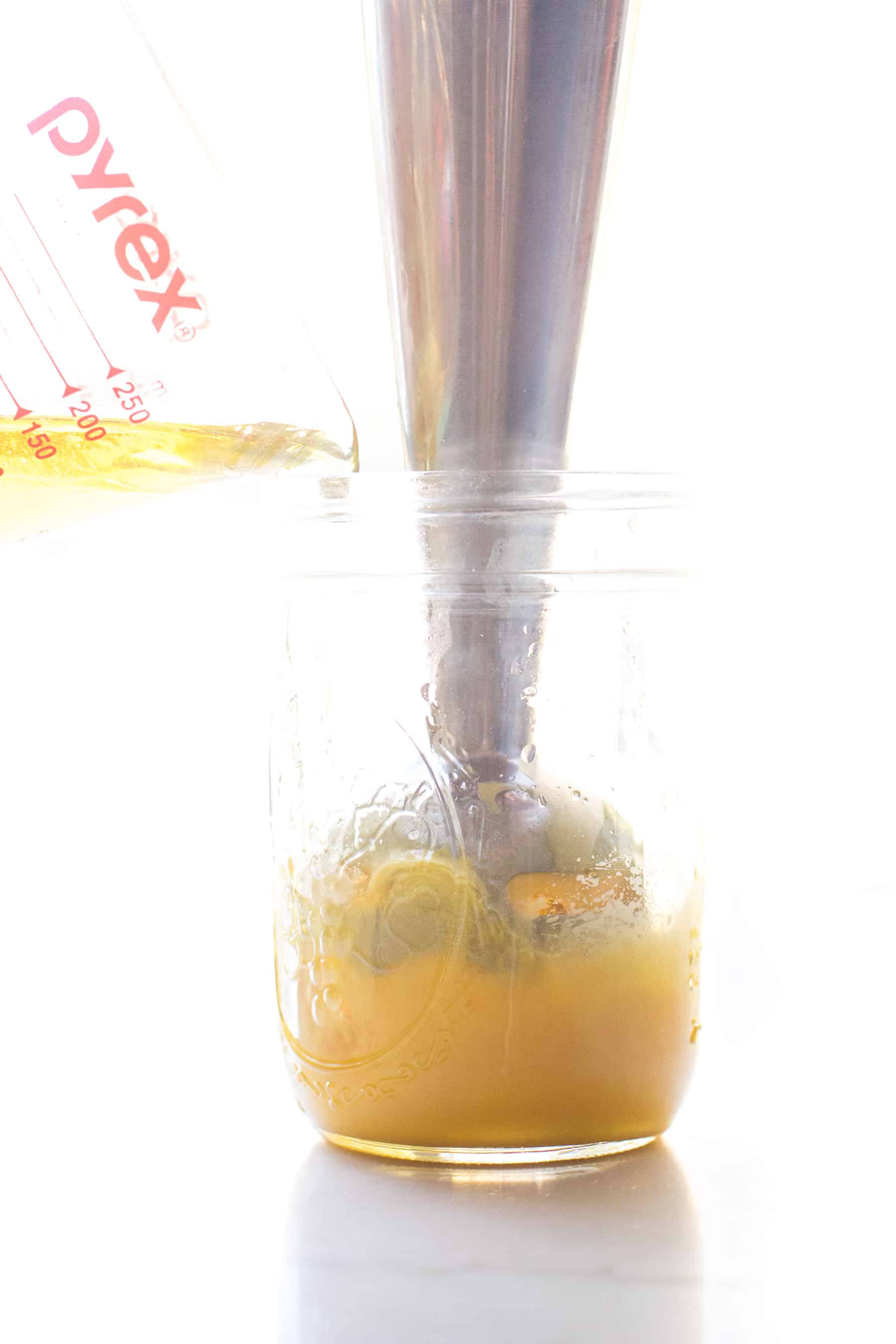 making hollandaise sauce in a mason jar with an immersion blender