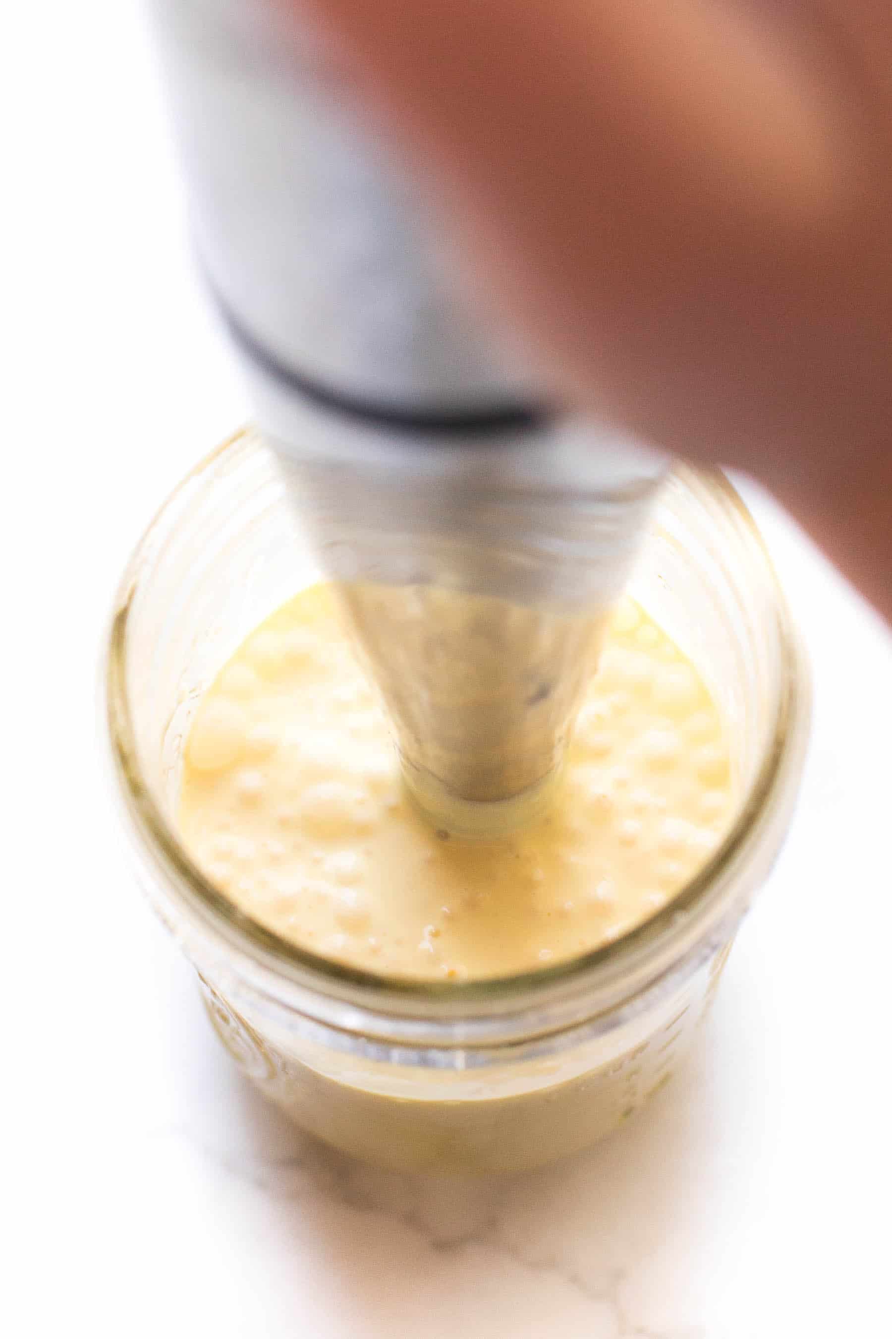 making hollandaise sauce in a mason jar with an immersion blender