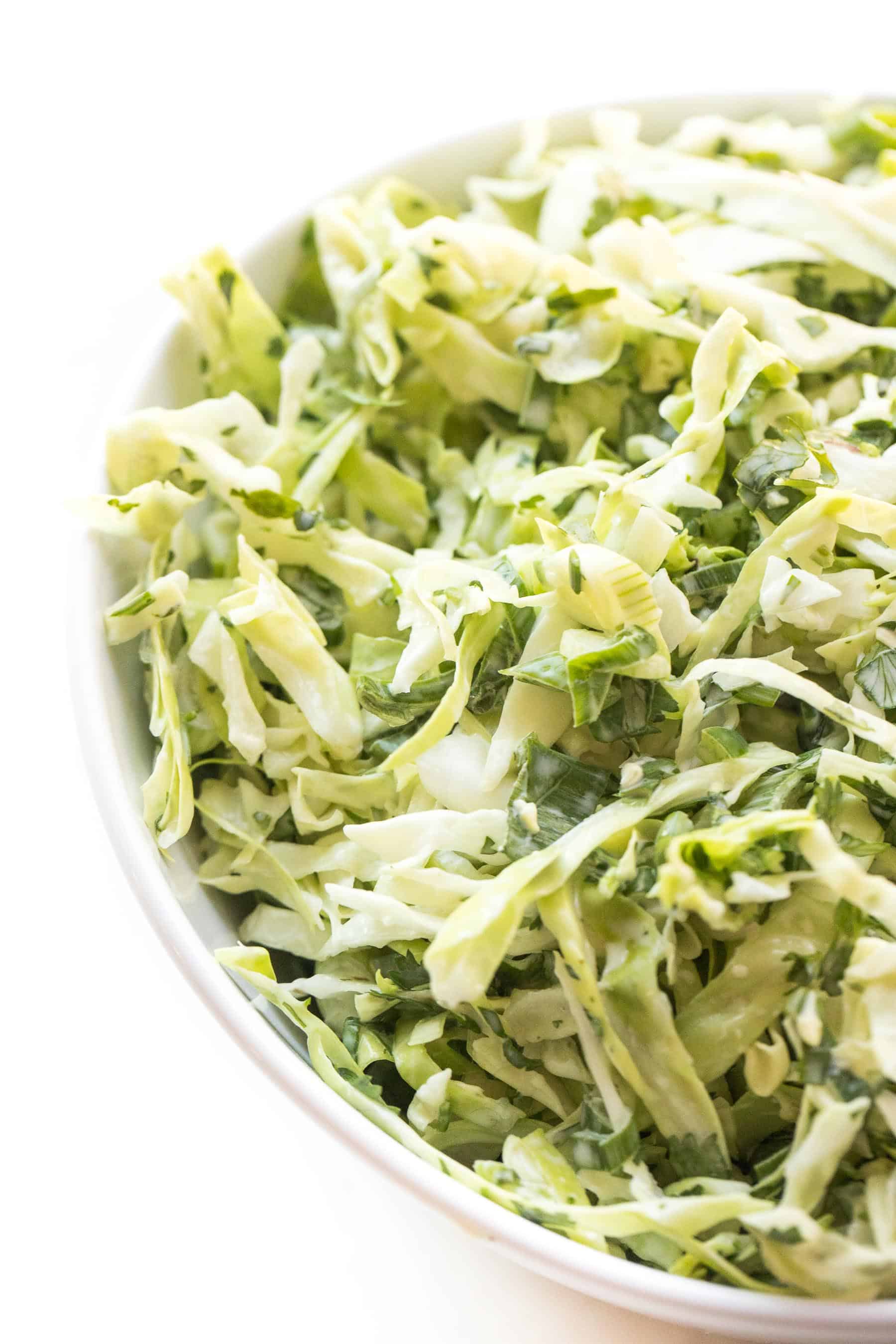 coleslaw in a white bowl and white background