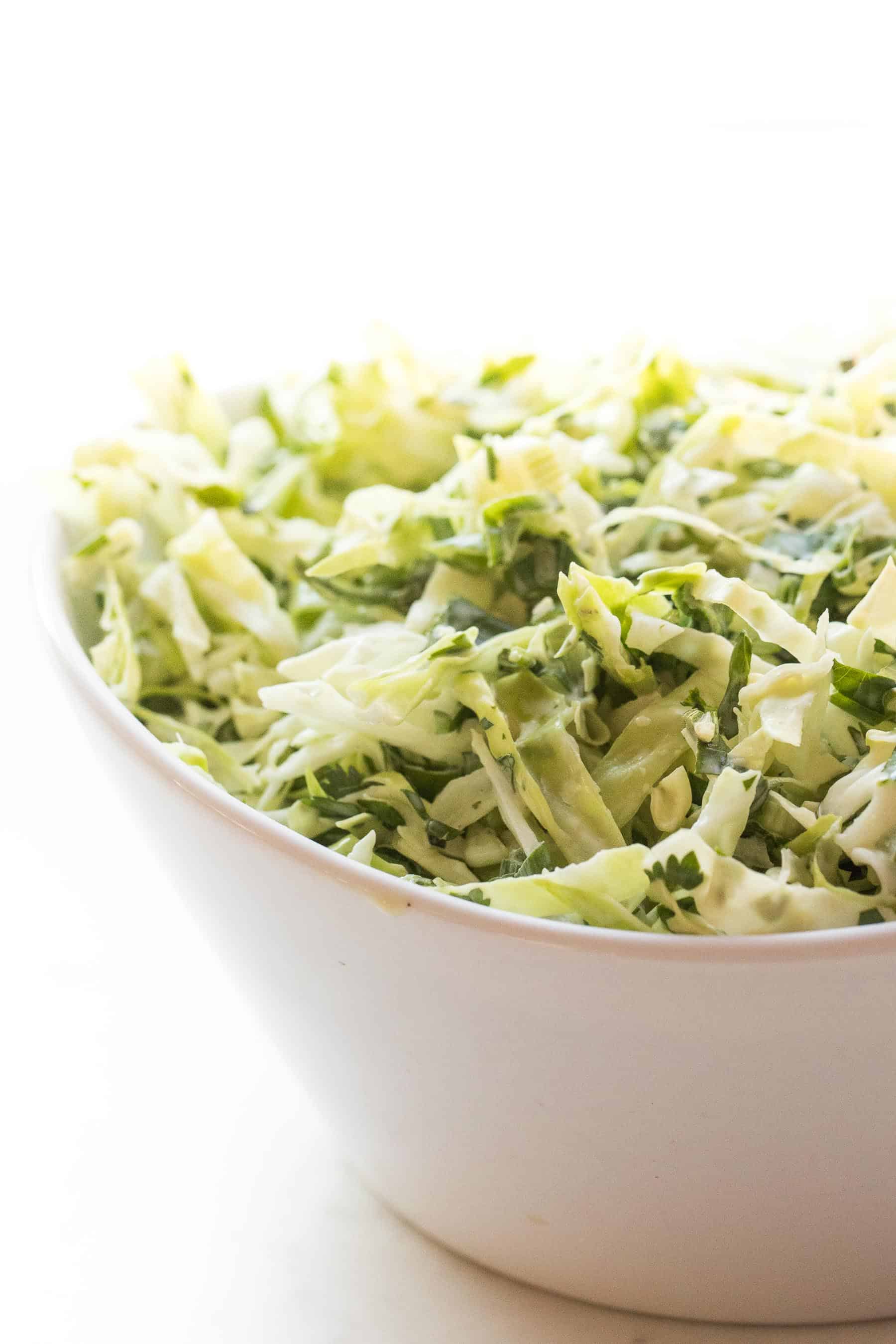 coleslaw in a white bowl and white background