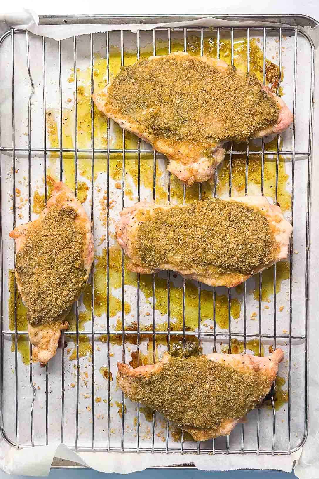 raw pesto chicken on a wire rack