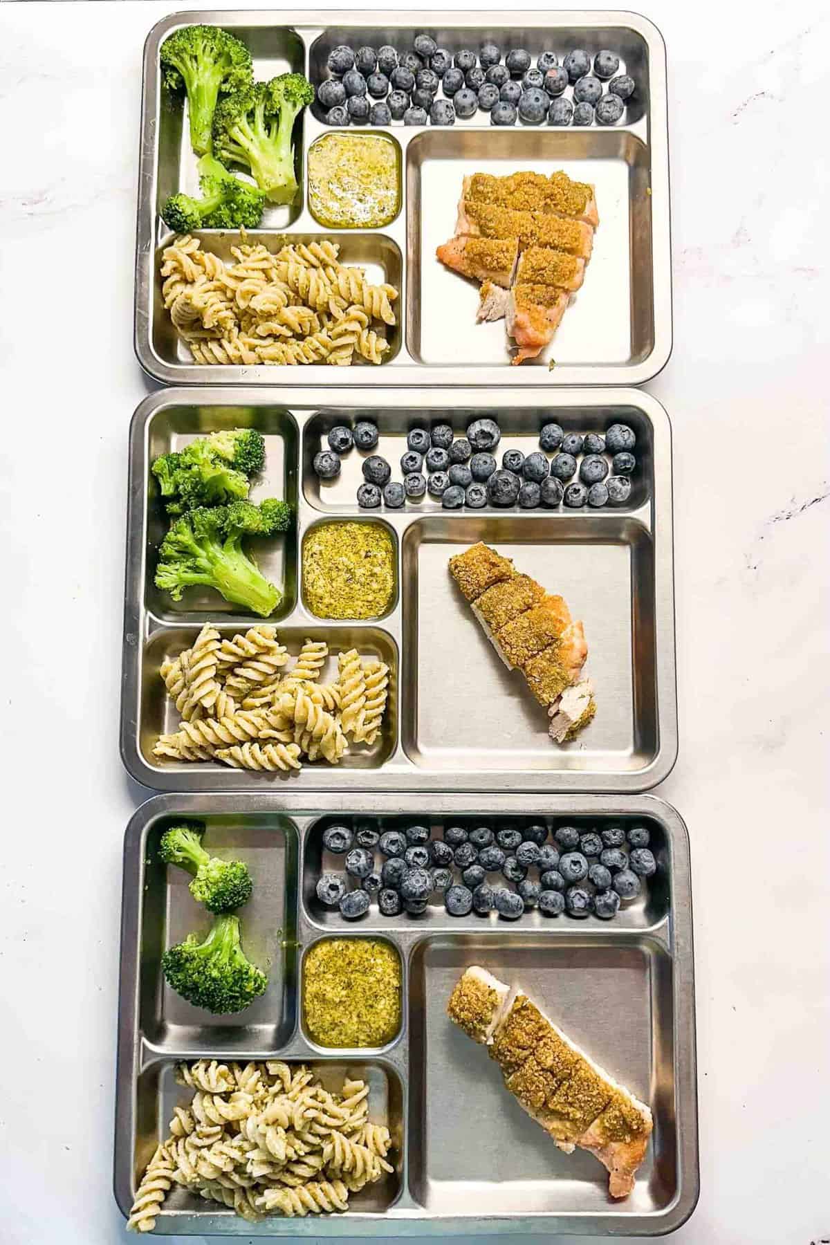 three metal kids plates showing how to serve this pesto chicken recipe to kids.