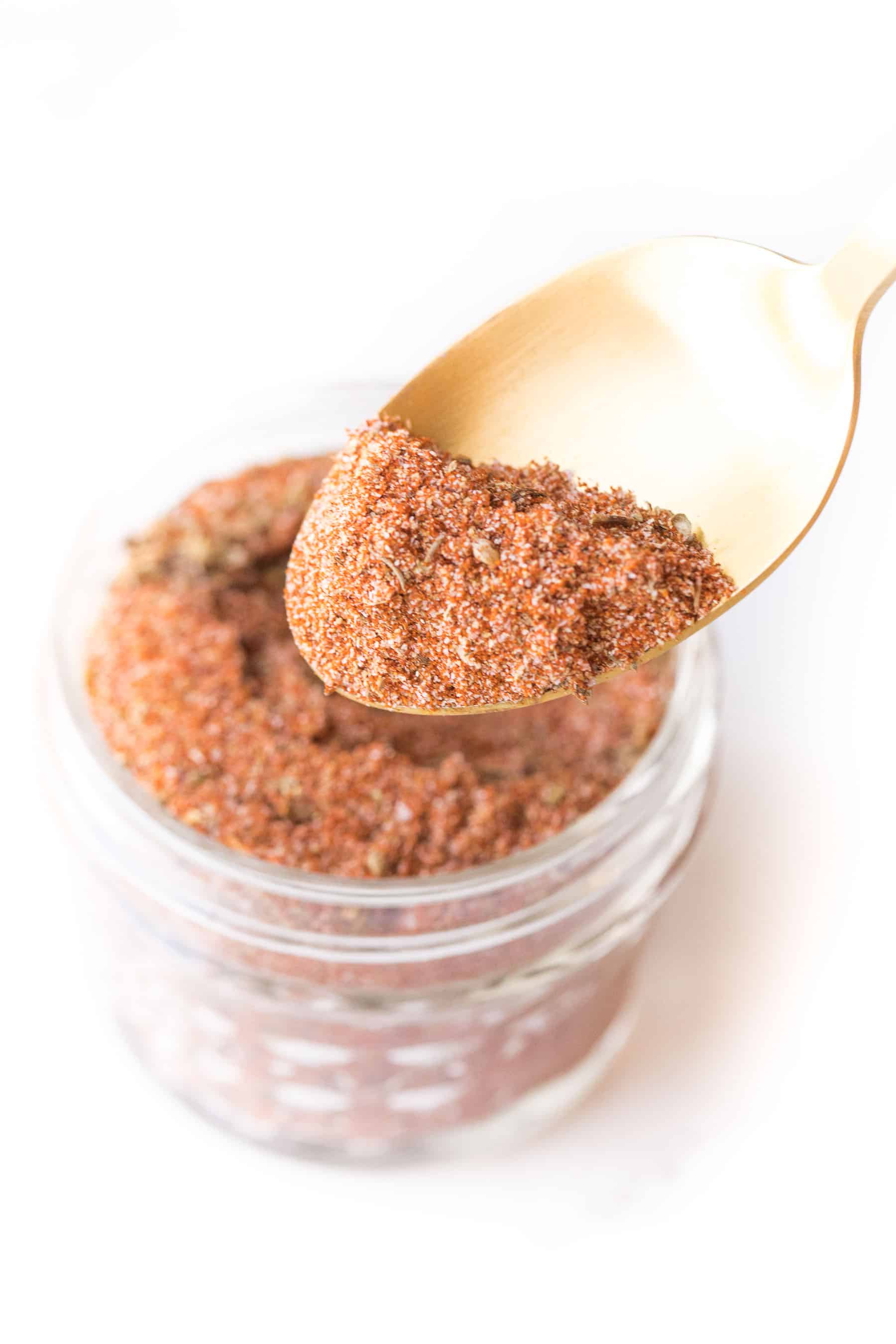 spoon of cajun seasoning on a white background