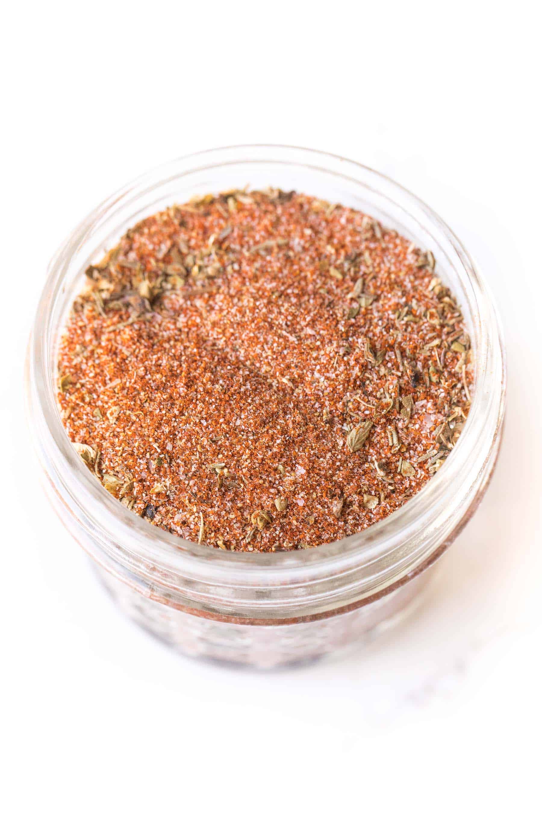 cajun seasoning in a small mason jar on a white background